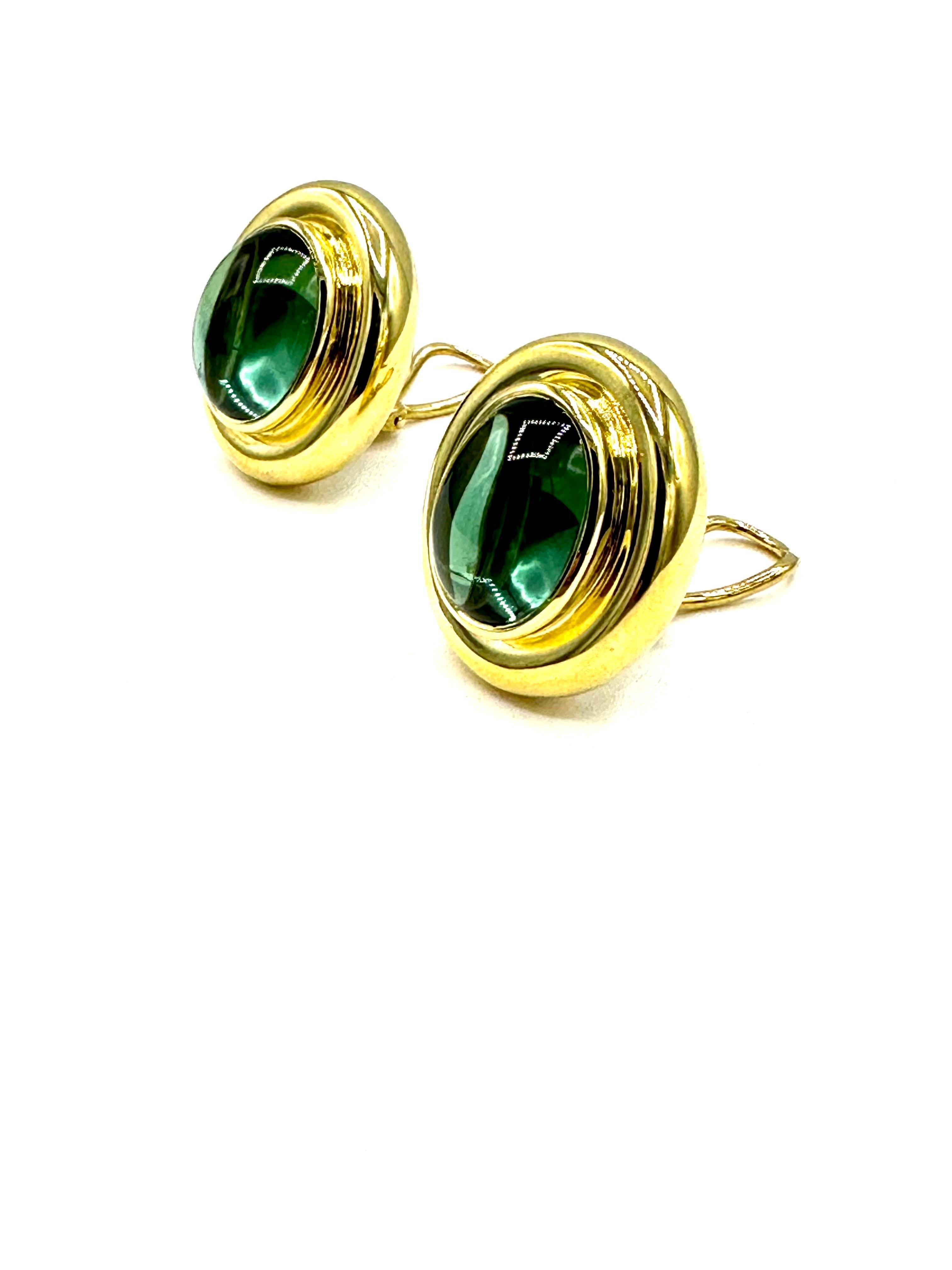 A pair of Paloma Picasso for Tiffany & Co. green Tourmaline lever back and post earrings in 18K yellow gold.   The two cabochon cut green Tourmalines have a total weight of 24.50 carats.  They are bezel set in a yellow gold oval frame.  The back of