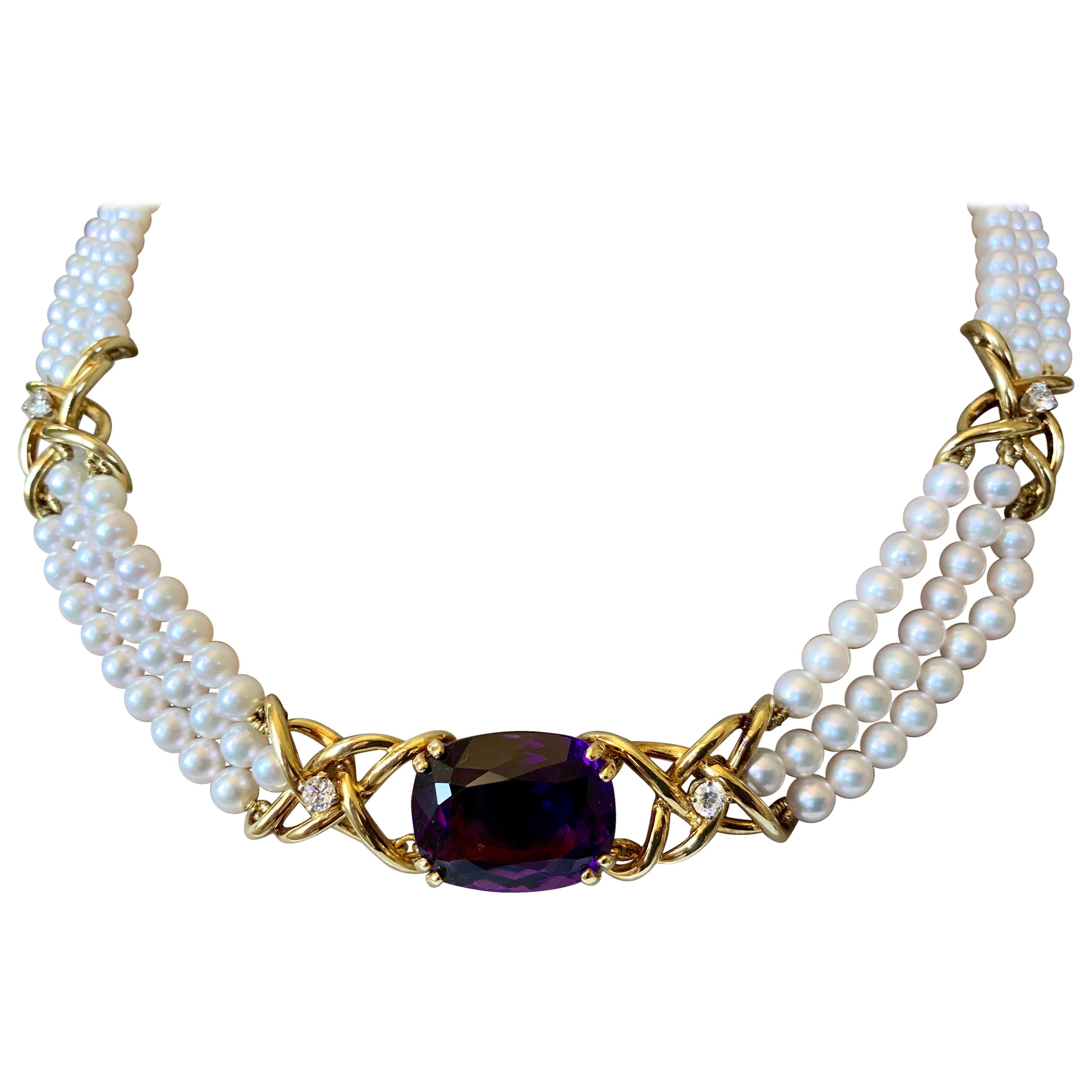 The 18 Karat yellow gold Tiffany necklace by Paloma Picasso is made of 3 strands of beautiful approximately 5 mm pearls accented with an oval Amethyst weighing ca. 20 ct  and 5 brilliant cut diamonds of ca. 0.60 ct. Length 43 cm. 