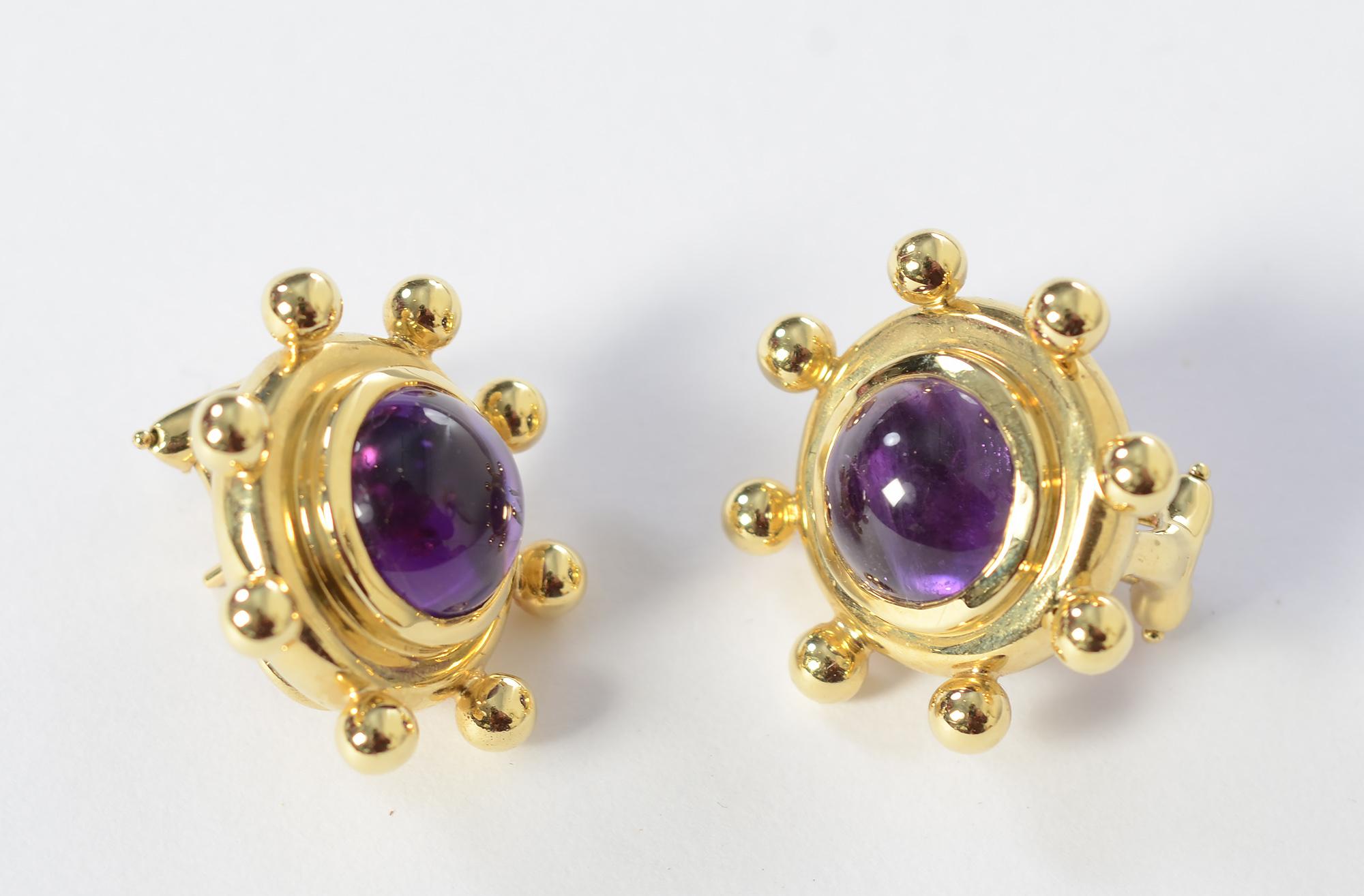 Chic 18 karat gold and amethyst earrings by Paloma Picasso for Tiffany. Each has a 9.3 mm richly colored amethyst surrounded by eight gold balls. Earrings are 15/16