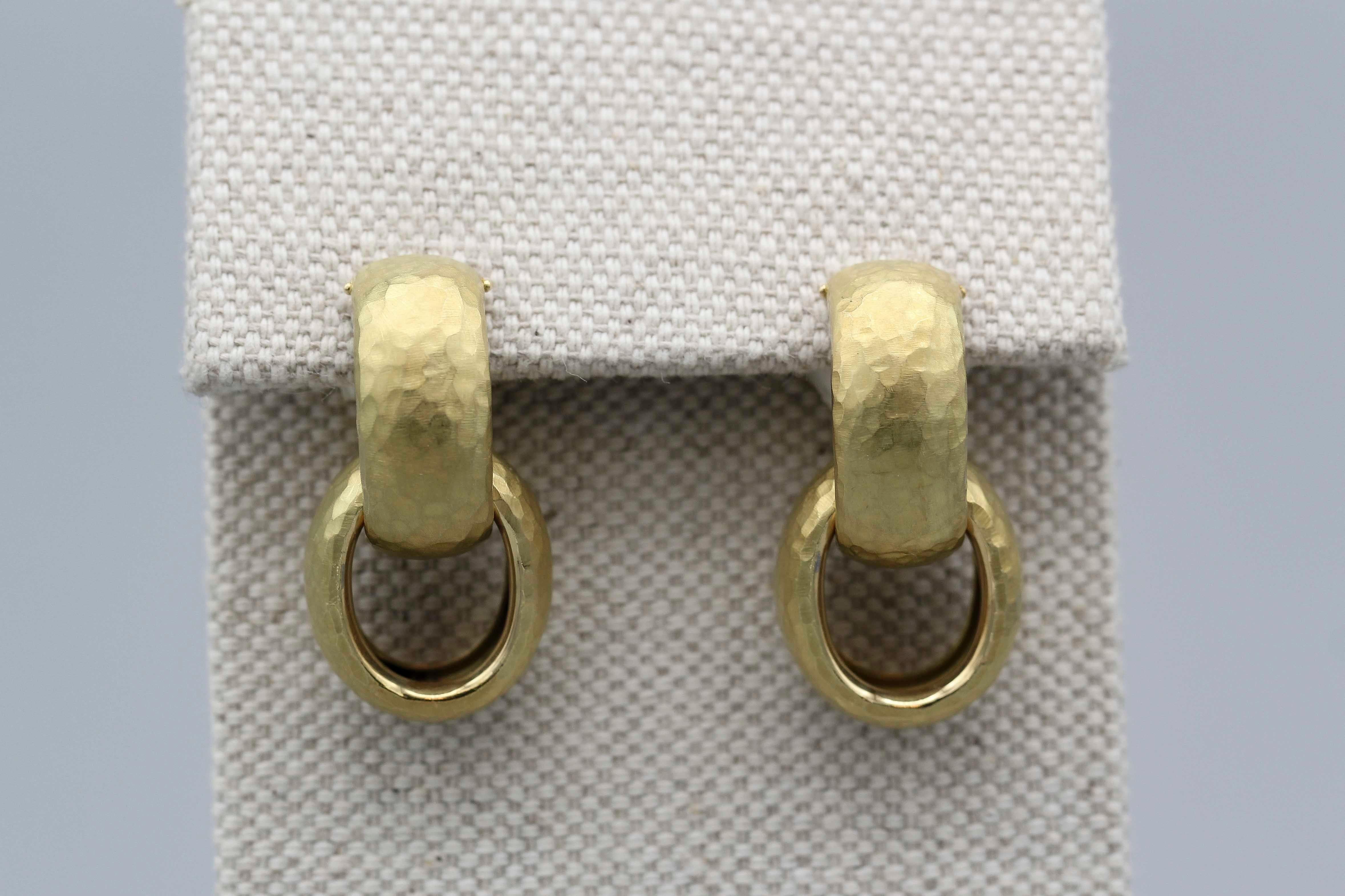 Fine pair of 18K gold drop earrings by Paloma Picasso for Tiffany & Co. They are designed as huggies with a removable link, over 1 inch in long, and feature a hammered gold design reminiscent of ancient jewelry.  Arguably the most famous design of