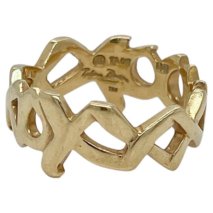 A fine Graffiti 'Love & Kisses' band ring.

Designed by Paloma Picasso for Tiffany & Co.

With alternating XXXs and OOOs in 18k yellow gold. 

Simply a terrific ring!

Date:
20th Century

Overall Condition:
It is in overall good, as-pictured, used