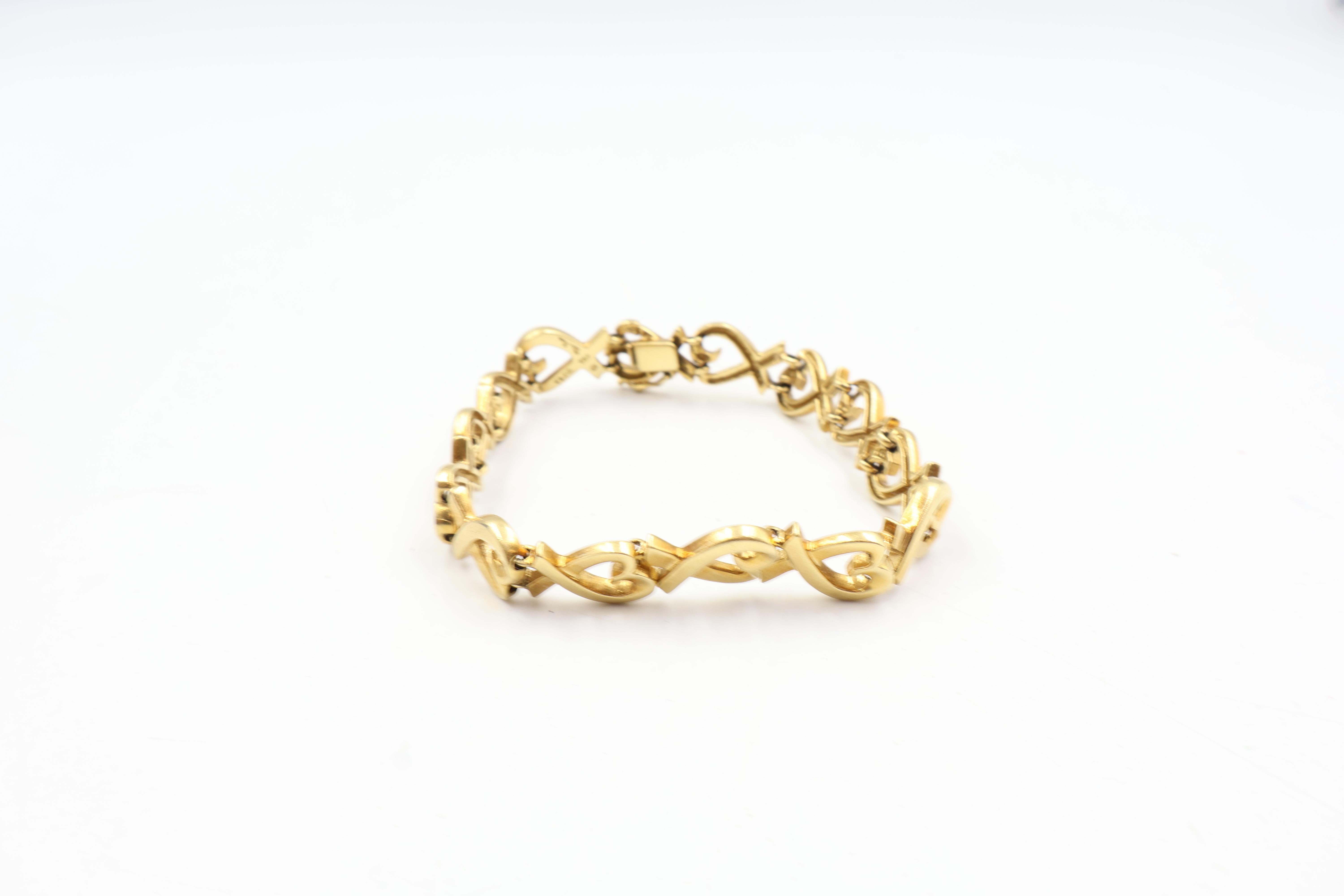 Paloma Picasso for Tiffany & Co Loving Heart Bracelet
18 K yellow gold
Safety clasp
Stamped Tiffany & Co, 750
Fits a 6 3/4 inch wrist
Total weight: 26 Grams