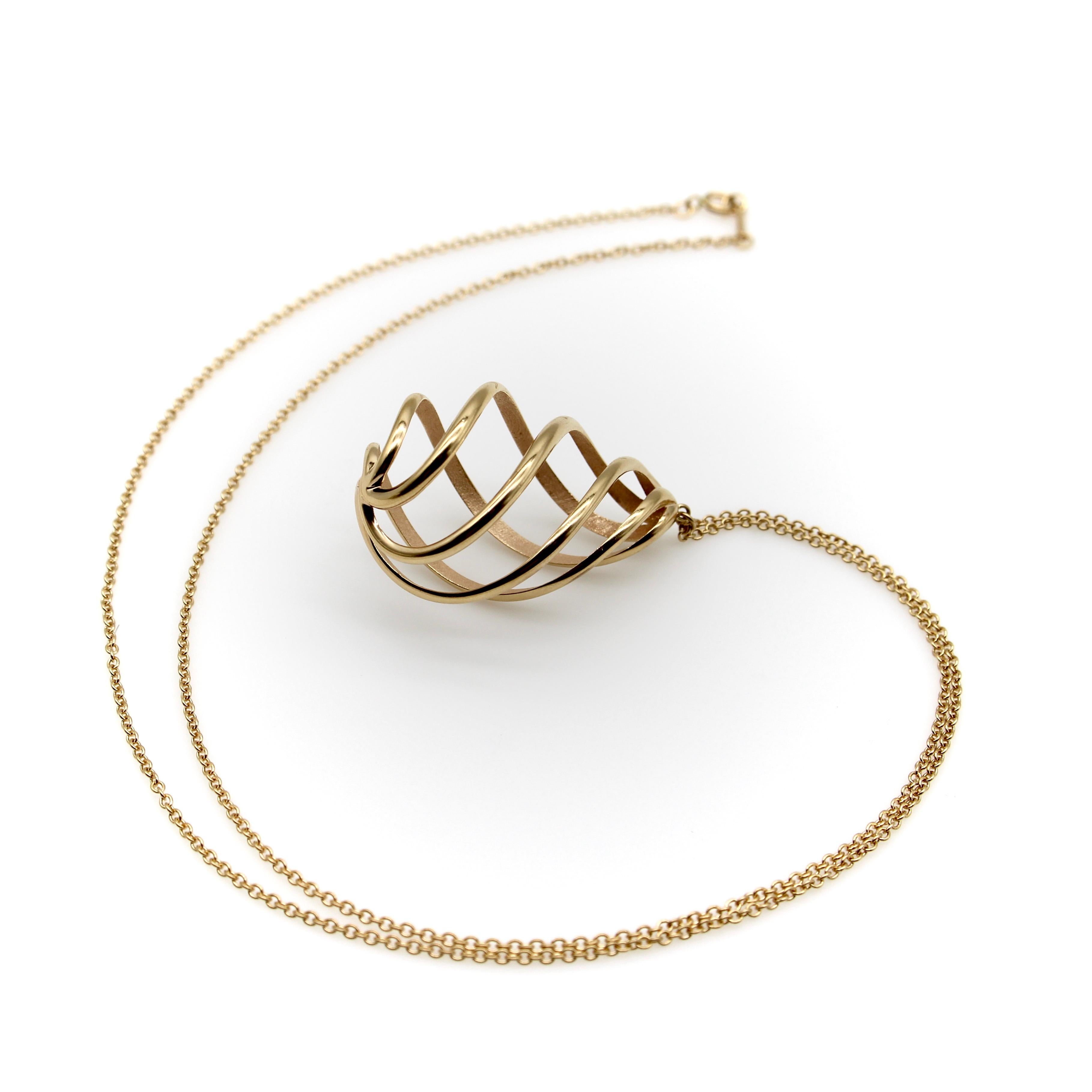 Designed by Paloma Picasso for Tiffany & Co., this 18k gold spiral pendant necklace is a highly sought-after retired shape. A spiral of 18k gold with a rosy patina creates this mesmerizing egg-shaped pendant. The exterior of the spiral has a glossy