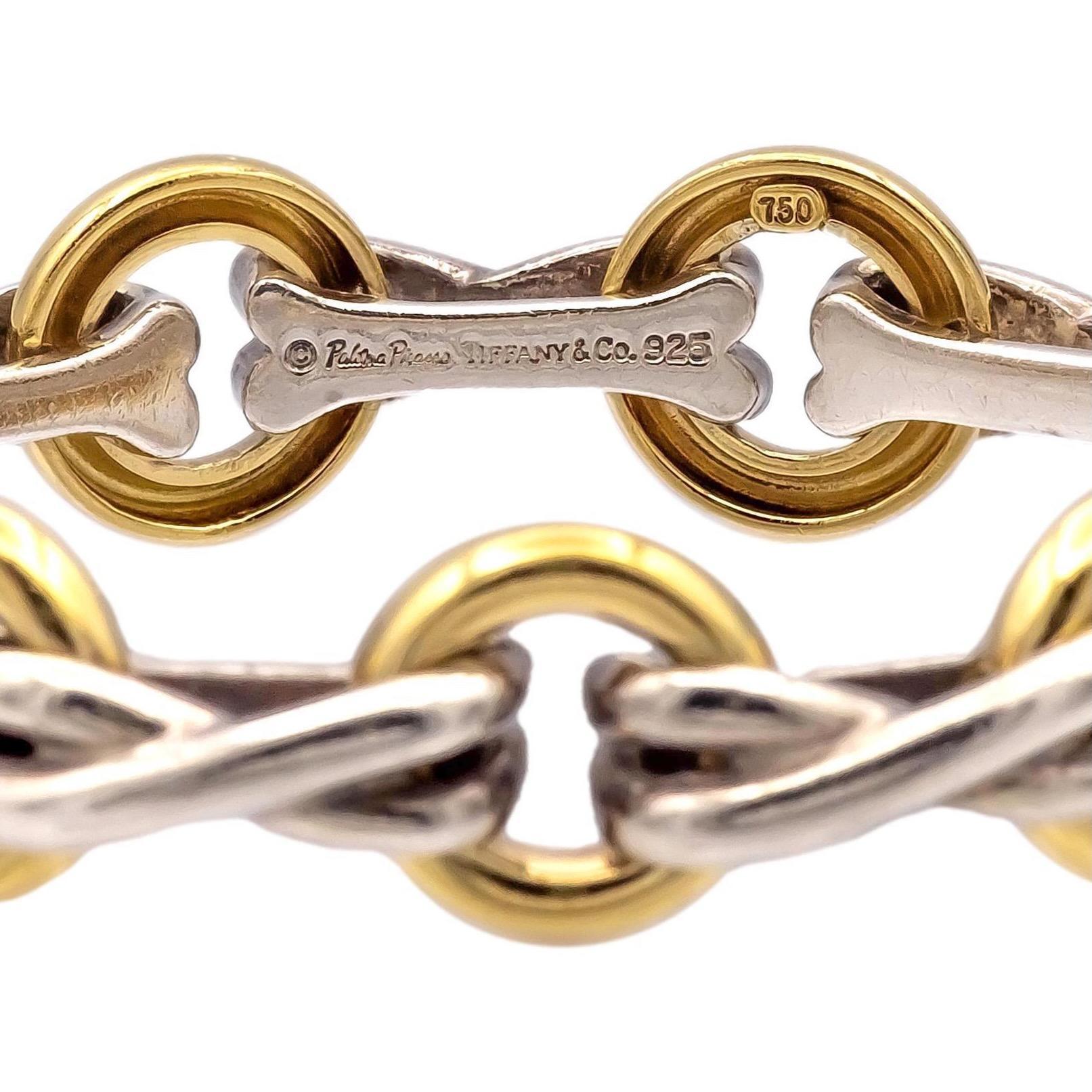 This vintage Tiffany & Co. bracelet, designed by Paloma Picasso, features the iconic X's and O's motif symbolizing hugs and kisses. Crafted from 18K yellow gold and sterling silver , the bracelet has a substantial weight of 41.2 grams, giving it a