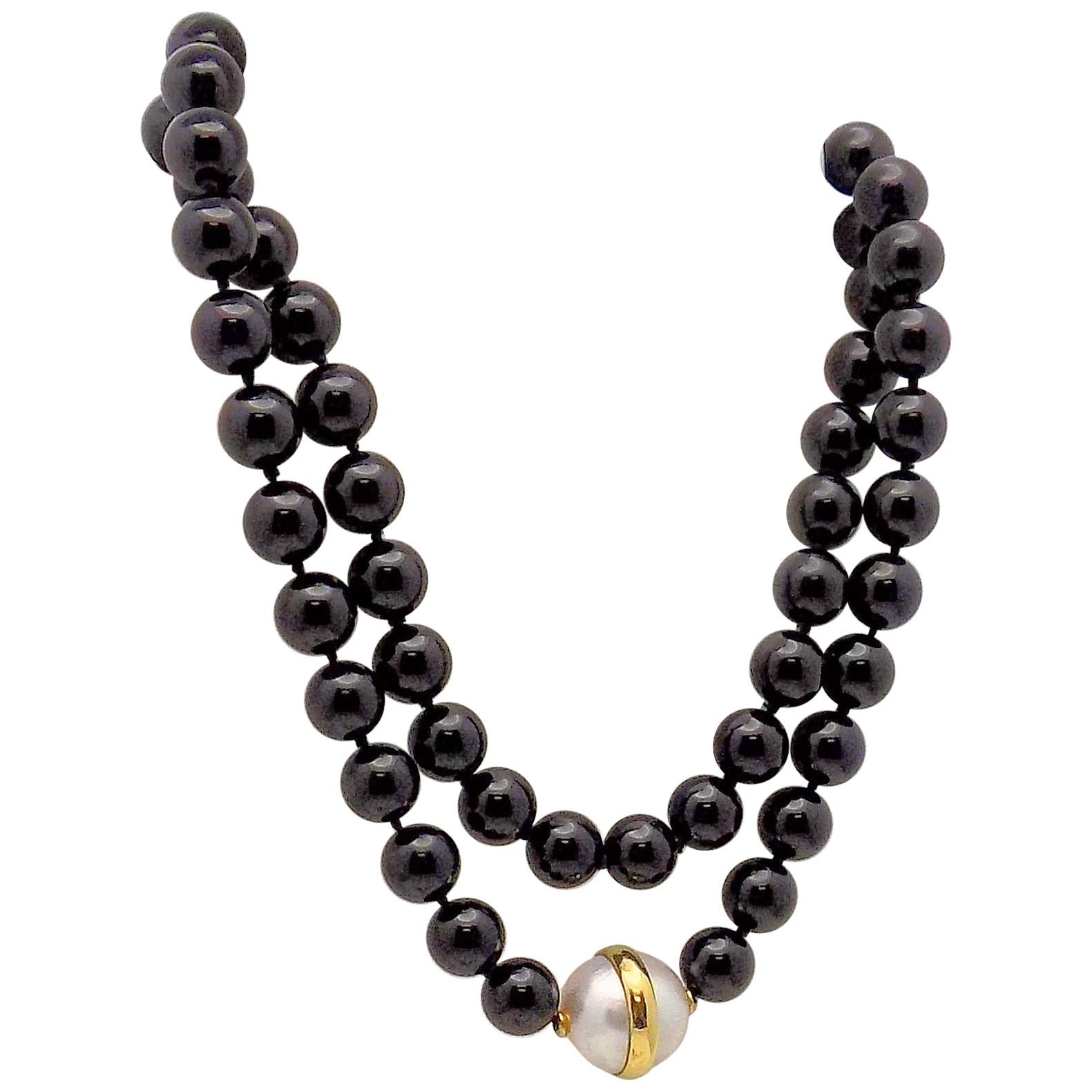 Elegant Suite of Jewelry consists of Black Onyx and Diamond Clip Earrings; Black Onyx and Diamond Ring; Black Onyx Bead and Mabé Pearl Necklace...First there is a Pair of 18 Karat Yellow Gold/White Gold Clip Earrings, 2 Round Brilliant Diamonds 0.20