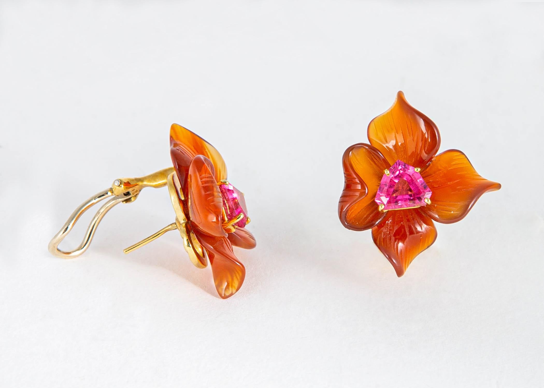 Paloma Picasso created only a few designs featuring beautiful carved gemstones in the mid 1980's  This pair of earrings centers around carved carnelian in a soft flower motif highlighted with bright pink faceted tourmaline. 1 inch in size. 