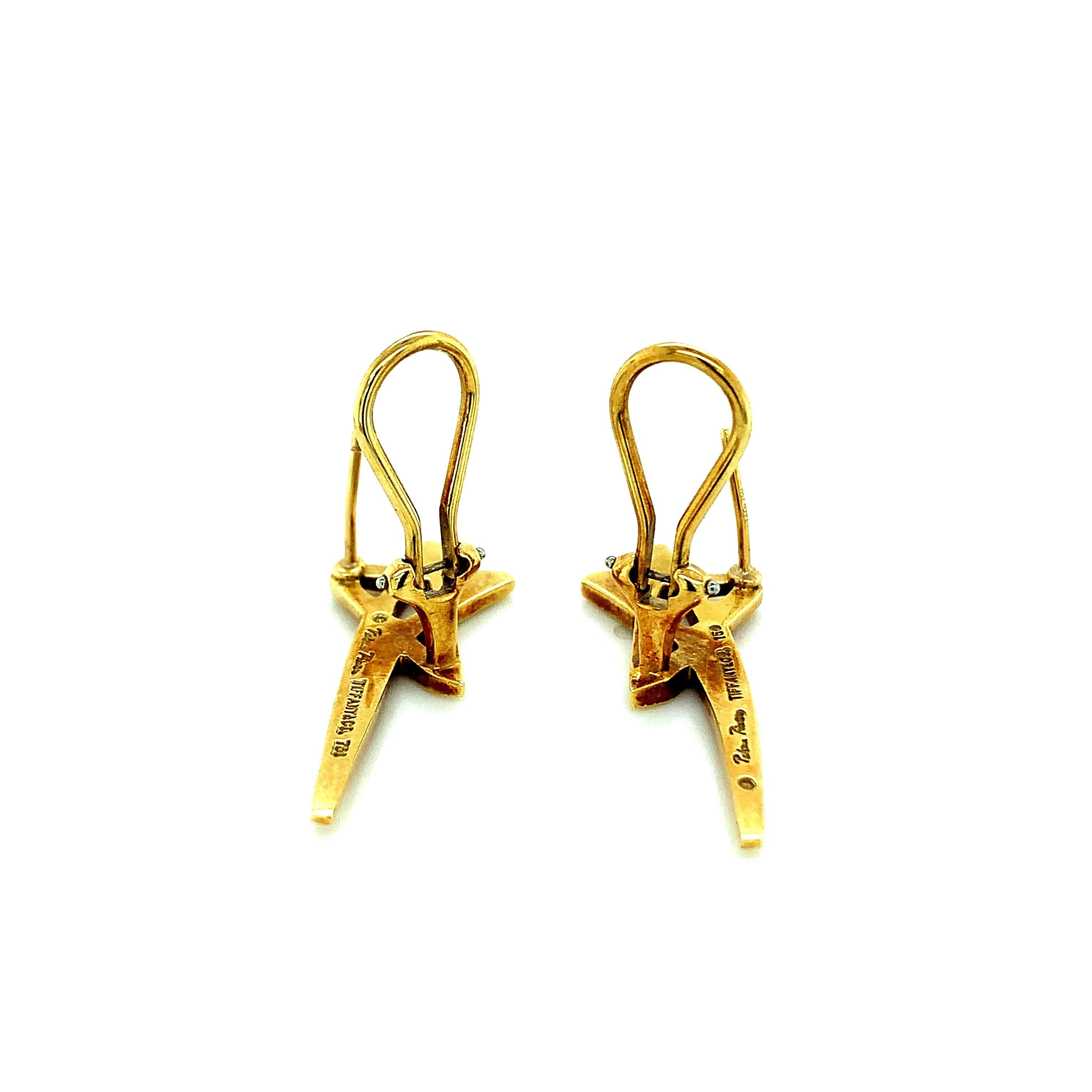 Paloma Picasso for Tiffany & Co. 18 karat yellow gold earrings featuring star motif. Marked: Paloma Picasso / Tiffany & Co. / 750. Total weight: 10.0 grams. Width: 1.2 cm. Length: 3.4 cm. 