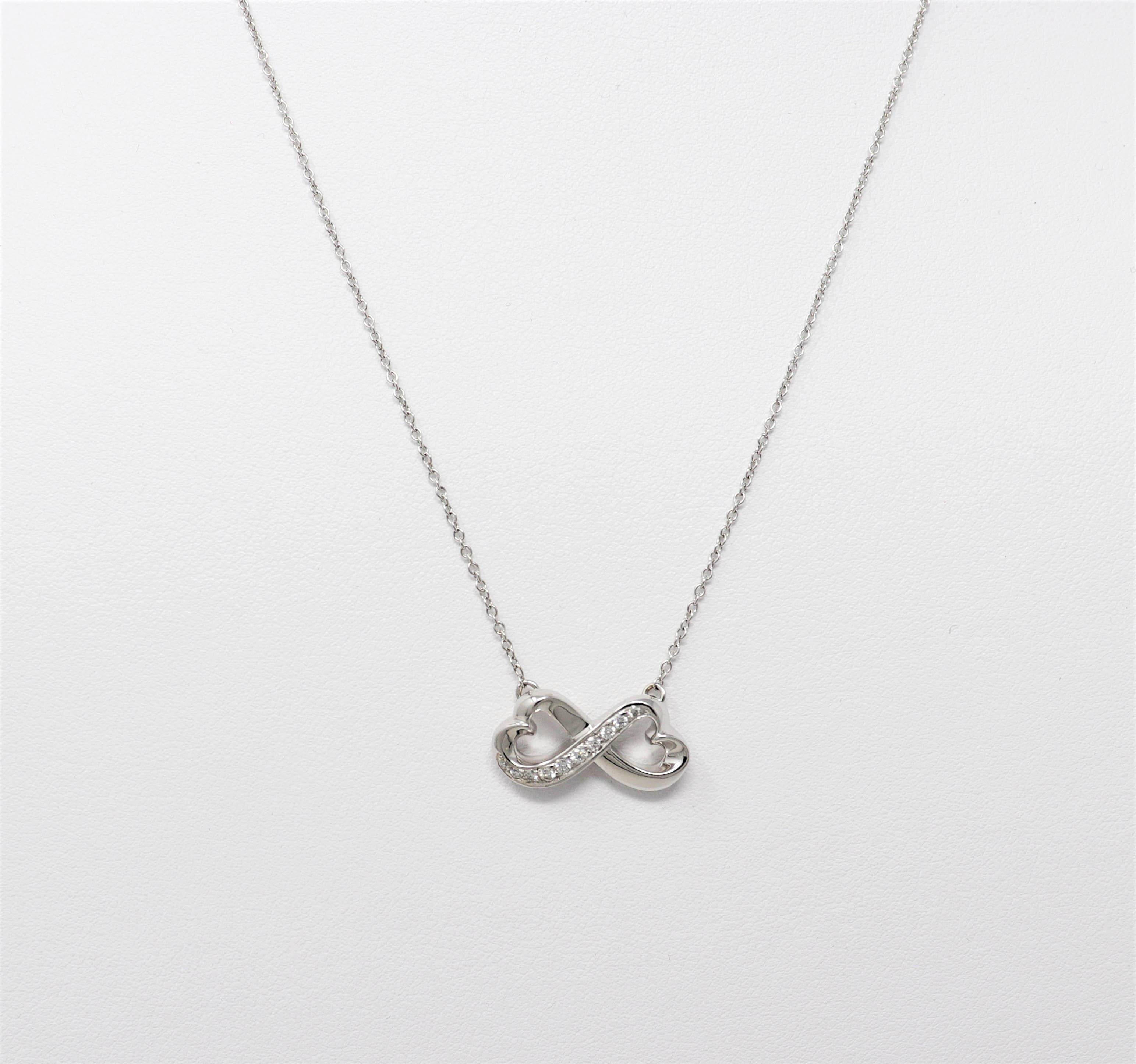 Designed exclusively for Tiffany & Co. by Paloma Picasso, this delicate diamond necklace will stand the test of time. The timeless open heart infinity symbol is embellished with glittering Tiffany diamonds, while the finely woven white gold chain