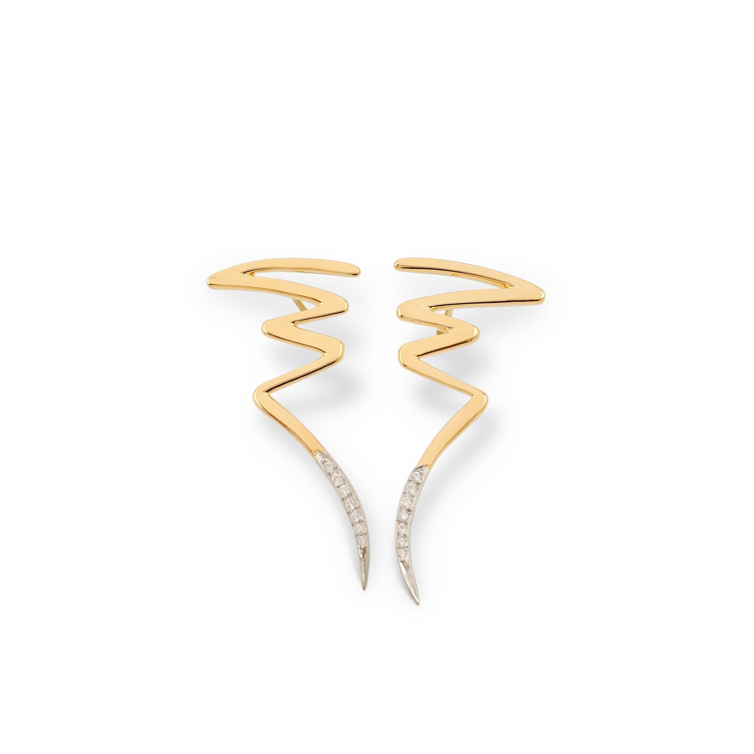 Authentic Paloma Picasso for Tiffany & Co. earrings feature an abstract zig-zag scribble of 18 karat yellow gold with a platinum tail set with an estimated 0.06 carats of round brilliant cut diamonds (E-F, VS). Signed Paloma Picasso, Tiffany & Co.,