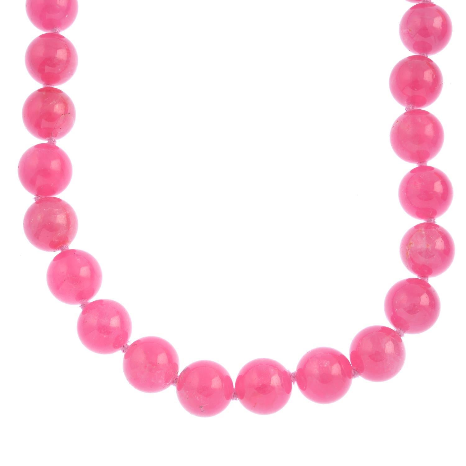 This is a classic; a silver rhodochrosite bead necklace by Paloma Picasso for Tiffany & Co. The necklace comprises thirty-one rhodochrosite beads in a deep vibrant pink colour, and fastens securely with an interlocking hoop clasp. 
The estimated
