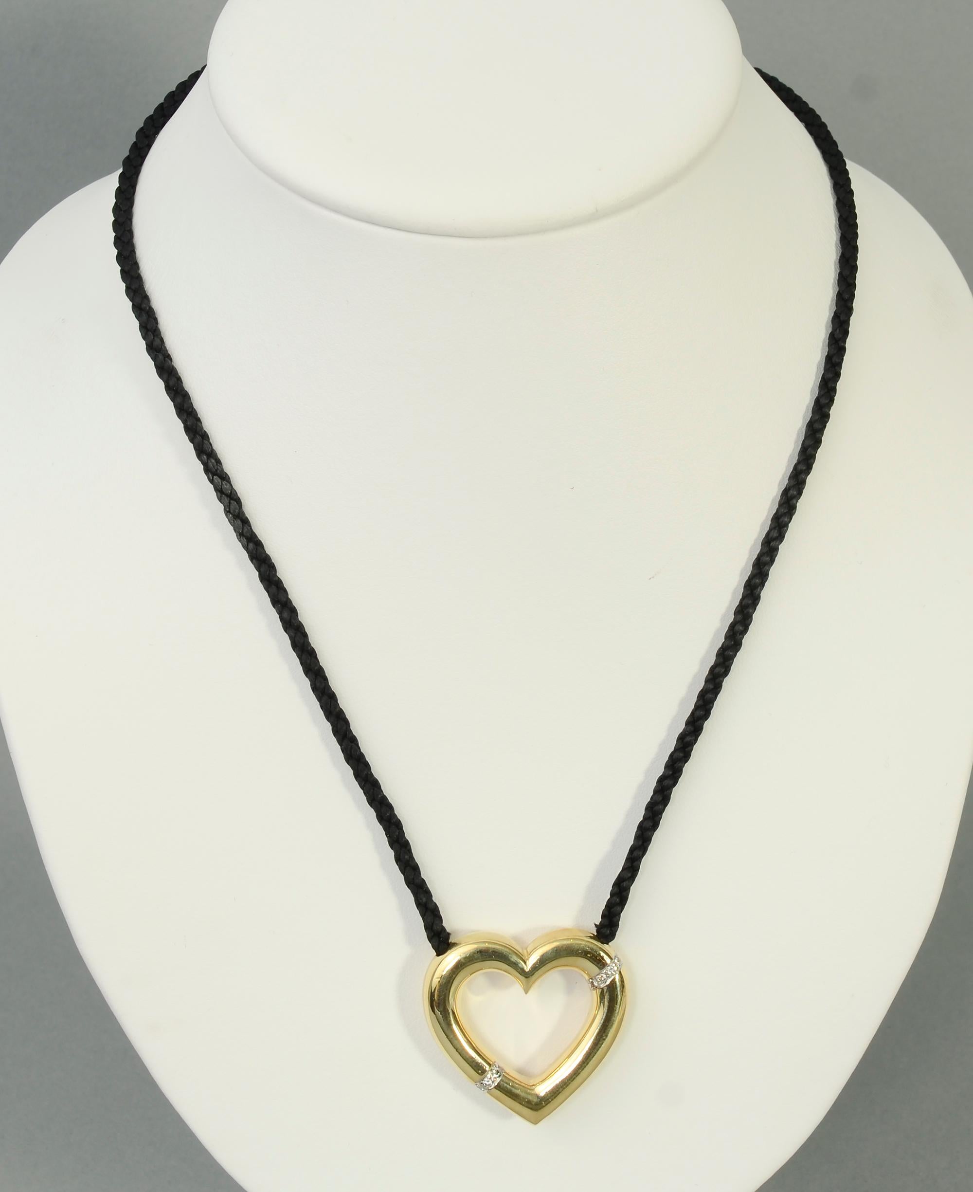Paloma Picasso for Tiffany open heart gold pendant with diamonds. It is on a black cord of adjustable length with gold ball tips. The necklace can be as long as 34 1/2 inches. The heart measures 1 1/4 inches  in width and length. Dated 1981.