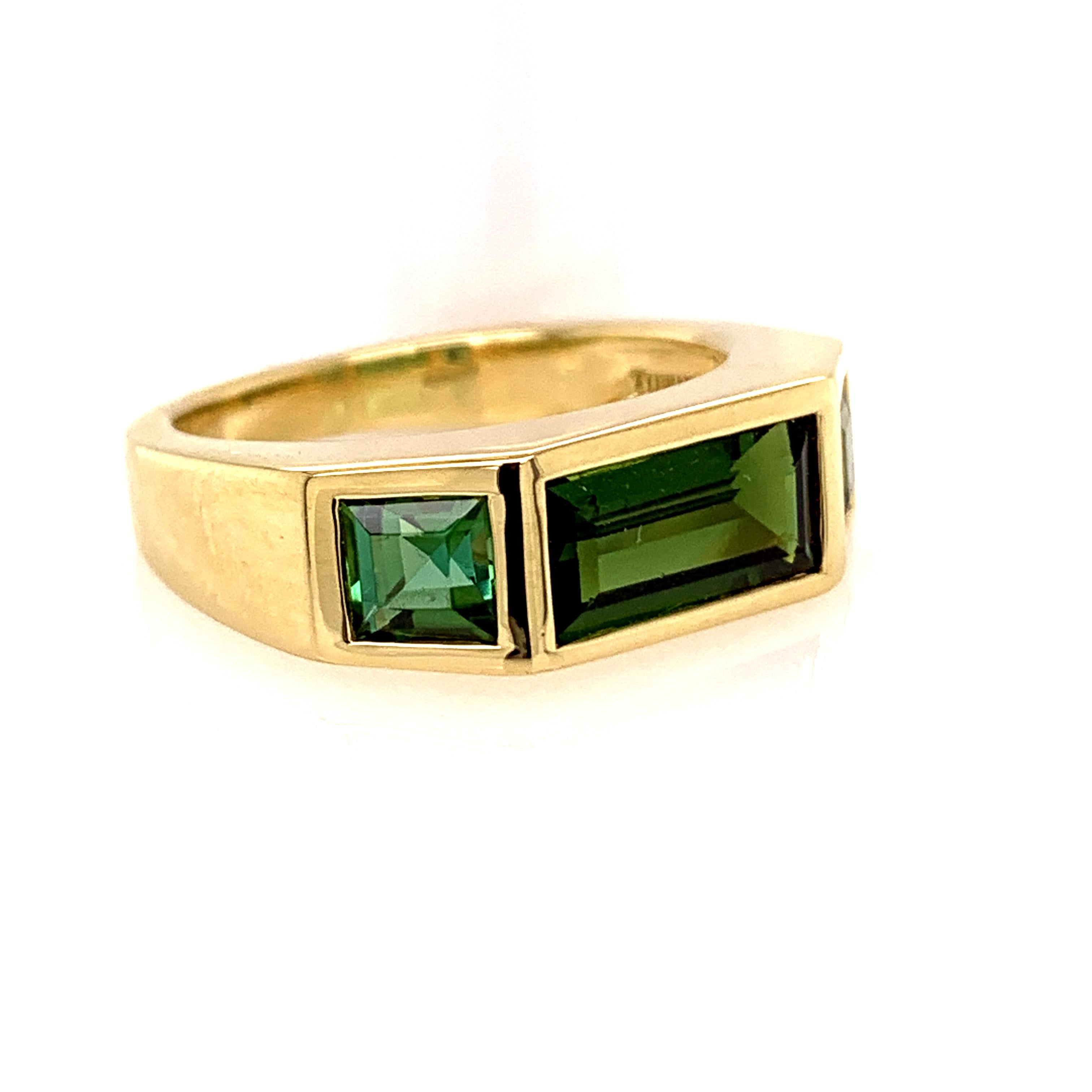 Beveled tourmaline ring.  Made and signed by Paloma Picasso for TIFFANY & CO.  18K yellow gold.  Three-stone tourmaline with emerald-cut tourmalines. Size 7 1/2 and can be custom-sized.  Contoured to hug the finger.  Part of the Studio Collection. 