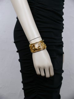 PALOMA PICASSO Parfums Vintage Pulsera brazalete con firma en cursiva en tono dorado