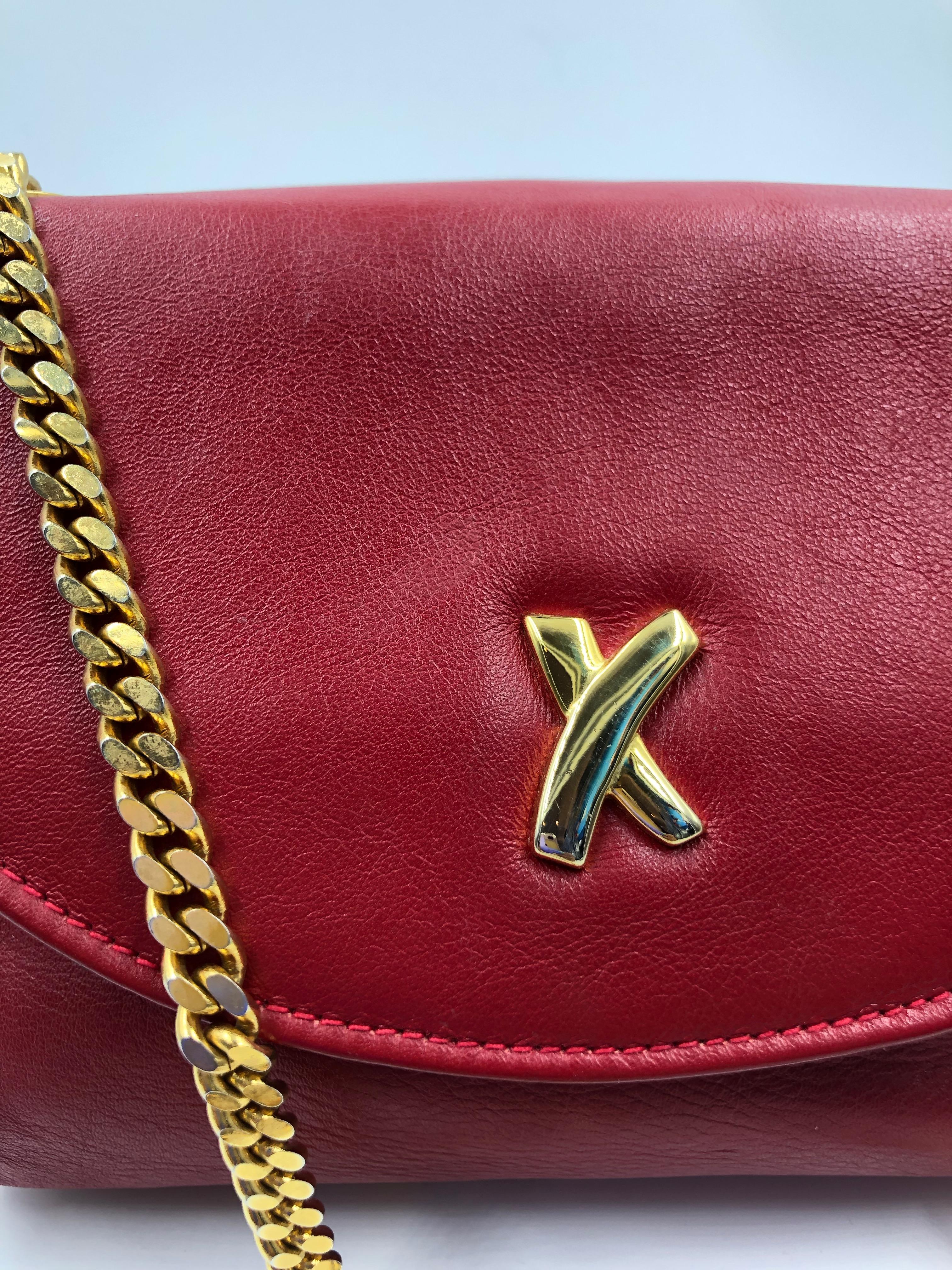 Paloma Picasso Red Leather Gold Chain Crossbody Disco Bag. Gold Signature X on front of bag. Gold hardware. Paloma Picasso signature embossed on back of bag.
Measurements taken flat:
Length - 7