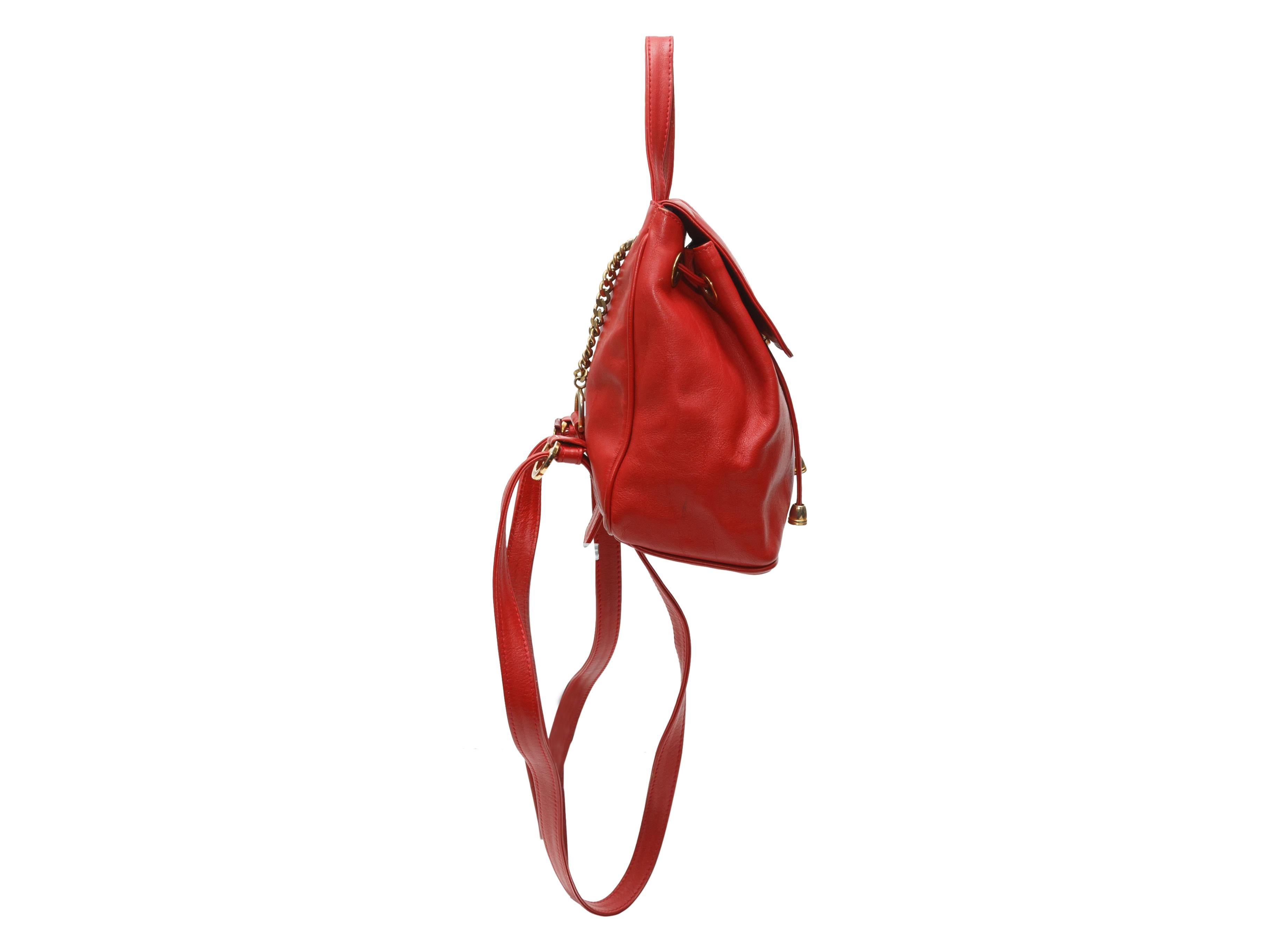 Product details: Red leather mini backpack by Paloma Picasso. Gold-tone hardware. Adjustable shoulder straps. Drawstring at interior top. Flap closure at front. 9