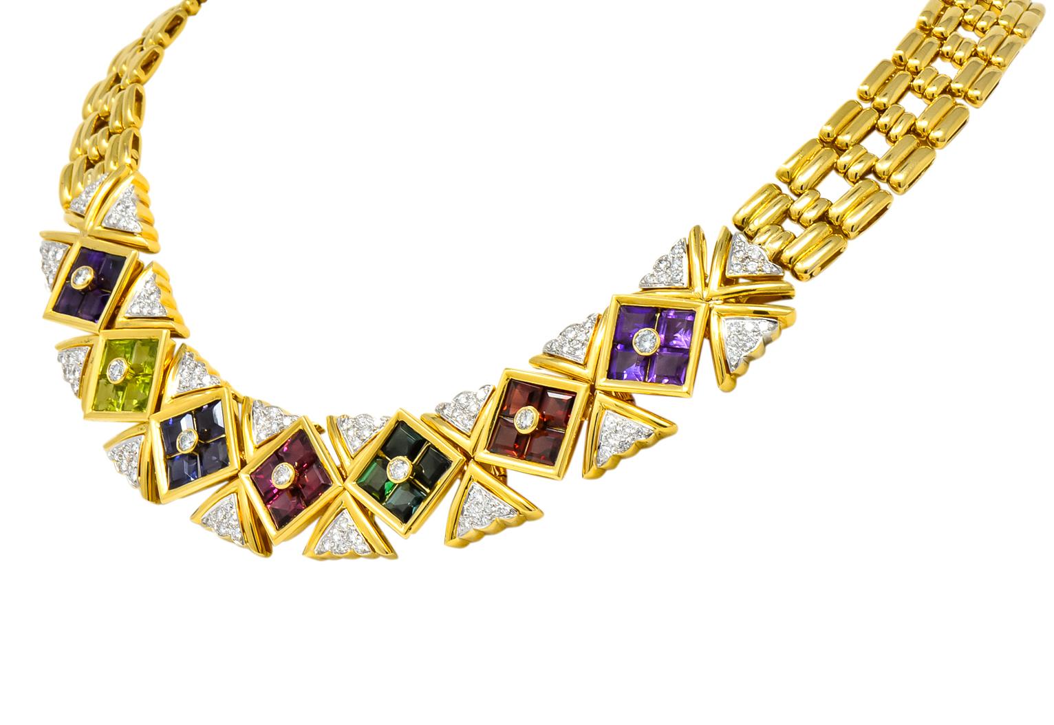 Collar style necklace comprised of ribbed polished gold links with front facing invisible set square cut gemstones in polished gold surrounds

Amethyst, peridot, iolite, garnet, and pink and green tourmaline weighing approximately 10.20 carats