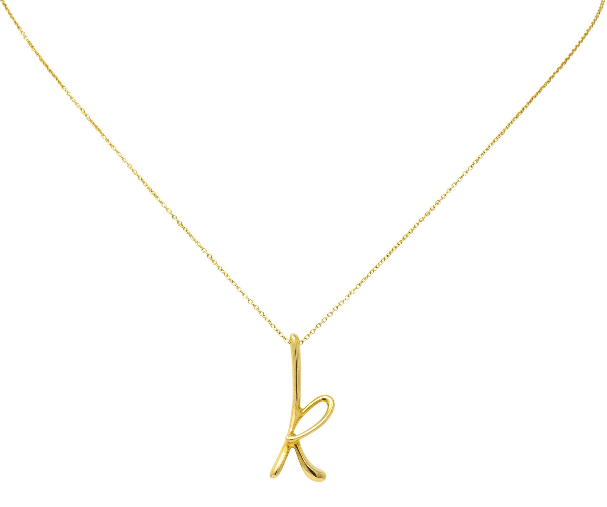 Featuring a stylized letter 'k' of high polished 18 karat gold

Accompanied by 18 karat gold cable style chain with spring ring clasp

Fully signed 750 (for 18 karat gold) Tiffany & Co. Spain with Paloma Picasso makers mark

Measures: letter 'k'