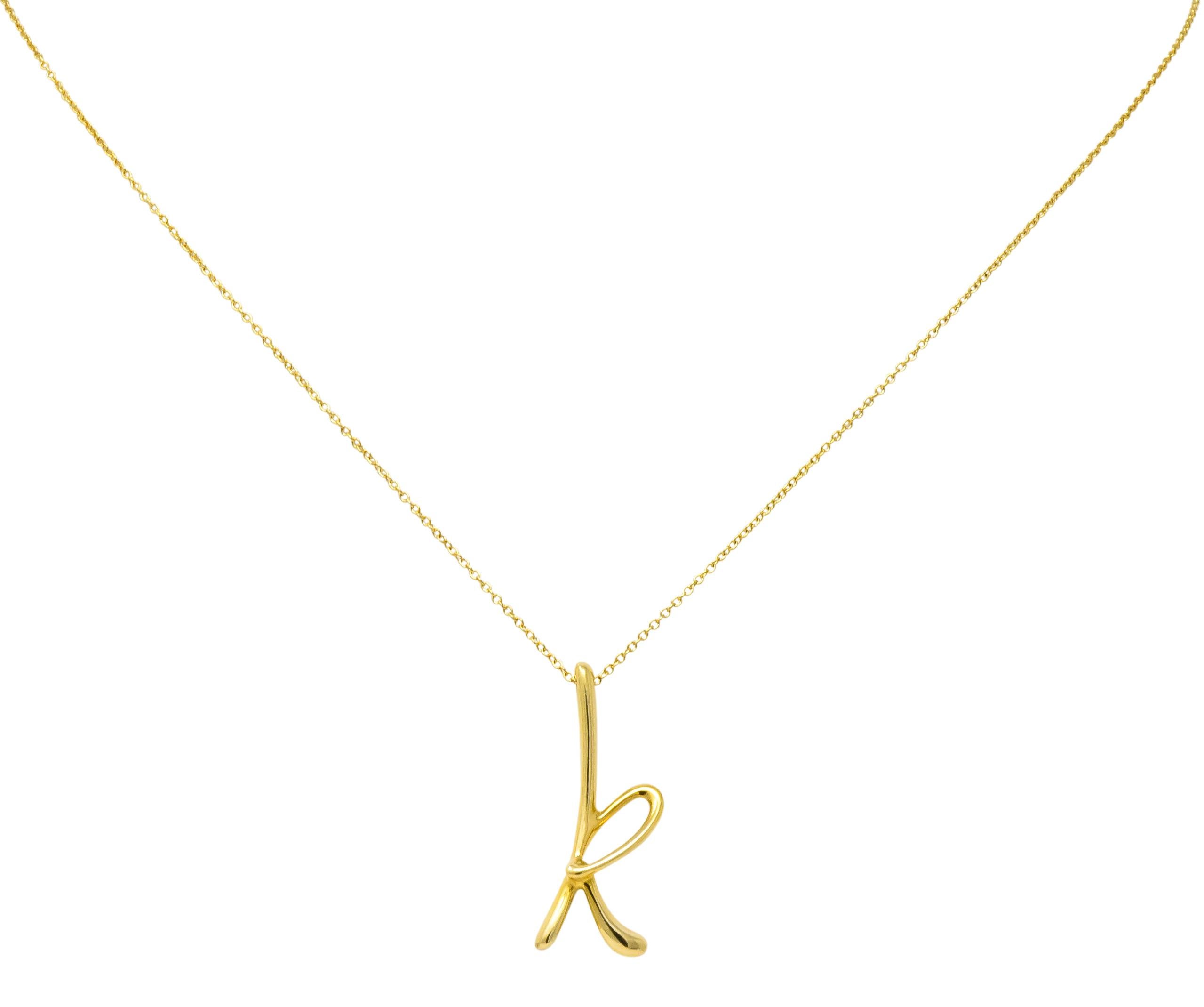 Featuring a stylized letter 'k' of high polished 18 karat gold

Accompanied by 18 karat gold cable style chain with spring ring clasp

Fully signed 750 (for 18 karat gold) Tiffany & Co. Spain with Paloma Picasso makers mark

Measures: letter 'k'