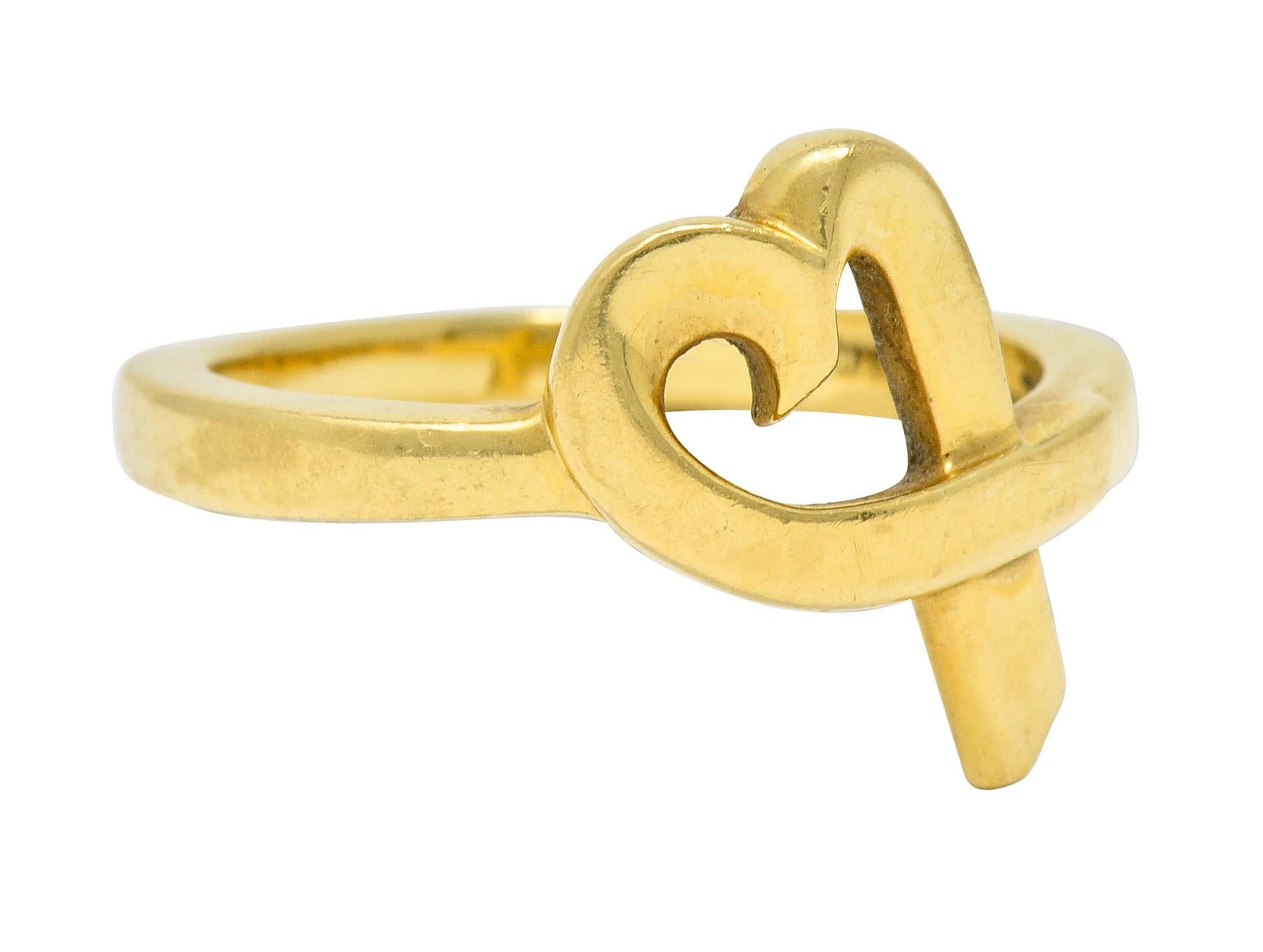 Band ring is designed as a ribboned open heart

Oriented East to West and seamlessly blends into shank

Stamped 750 for 18 karat gold

Fully signed Paloma Picasso and Tiffany & Co.

From the vintage 1980's Loving Heart collection

Ring Size: 7 1/2 &