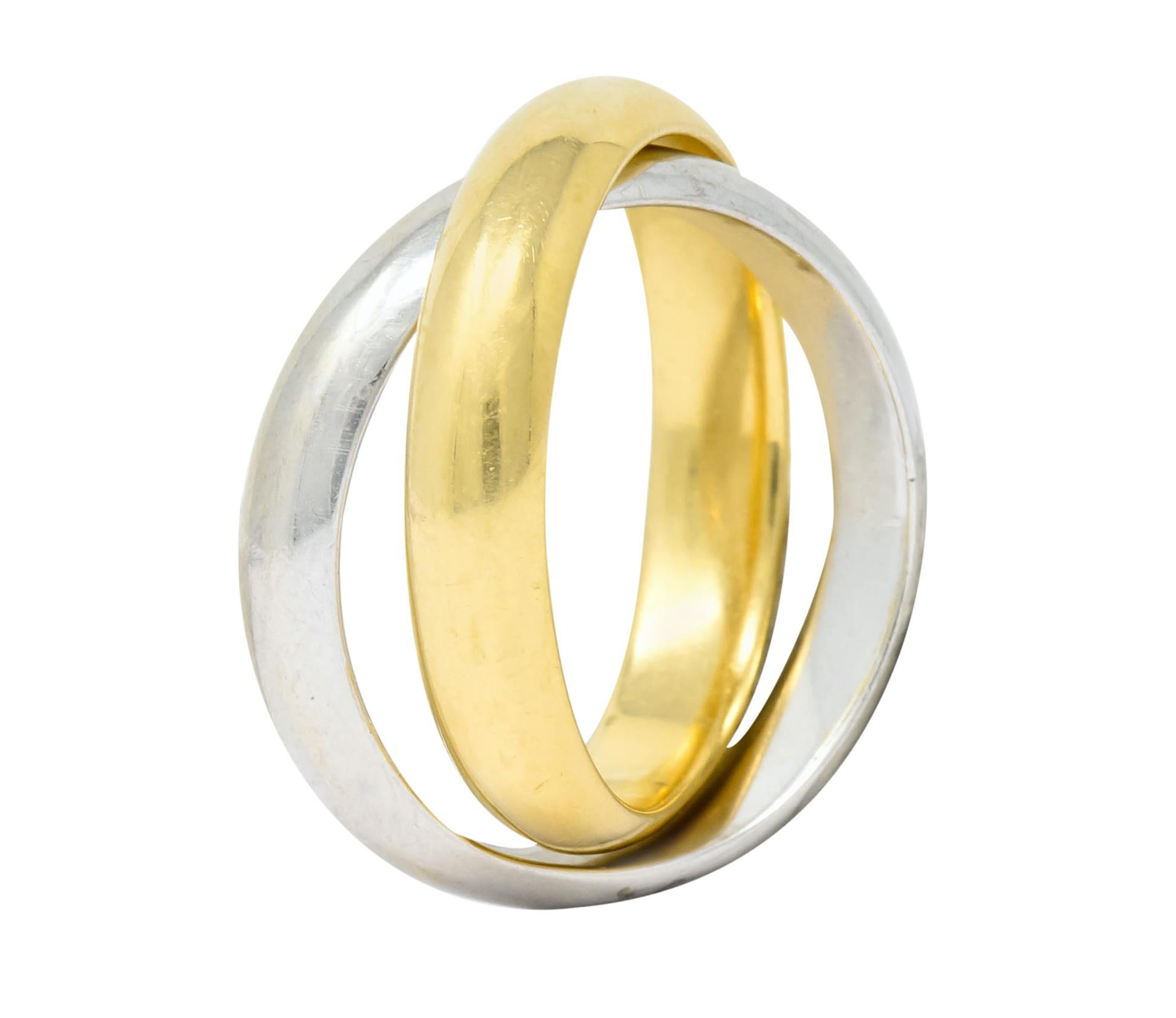 Designed as two intersecting white and yellow gold band rings with a high polished finish

From the Melody collection circa 1980

Fully signed Paloma Picasso Tiffany & Co.

Stamped Au750 for 18 karat gold

Ring Size: 5 & not sizable

Top measures:
