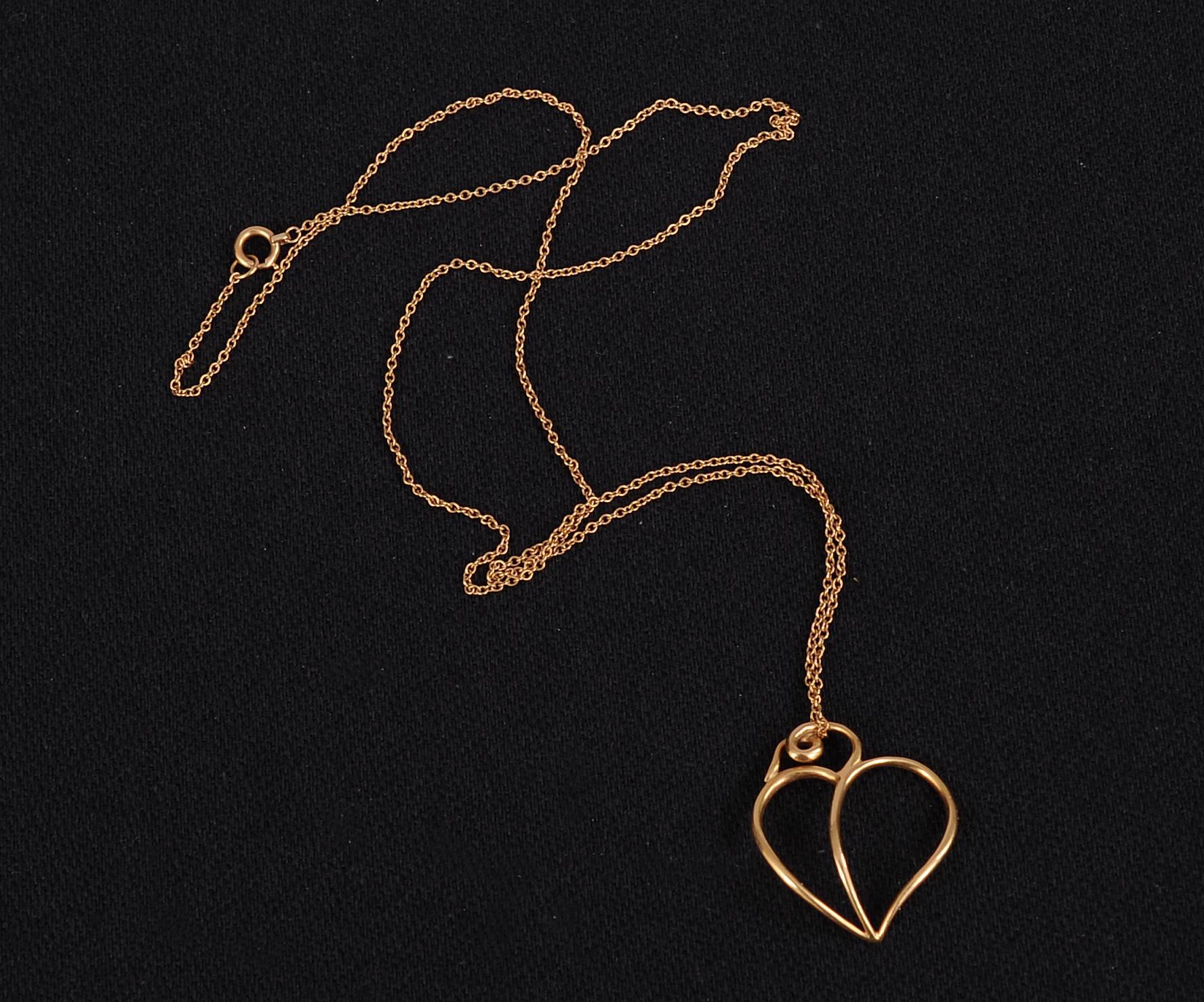 Paloma Picasso designed a  striking 18K gold heart pendant suspended from  a complementary gold chain for Tiffany & Co. in 1980. The heart is signed Paloma Picasso, 18K, 1980, and Tiffany & Co. on the back. It is in excellent condition and comes