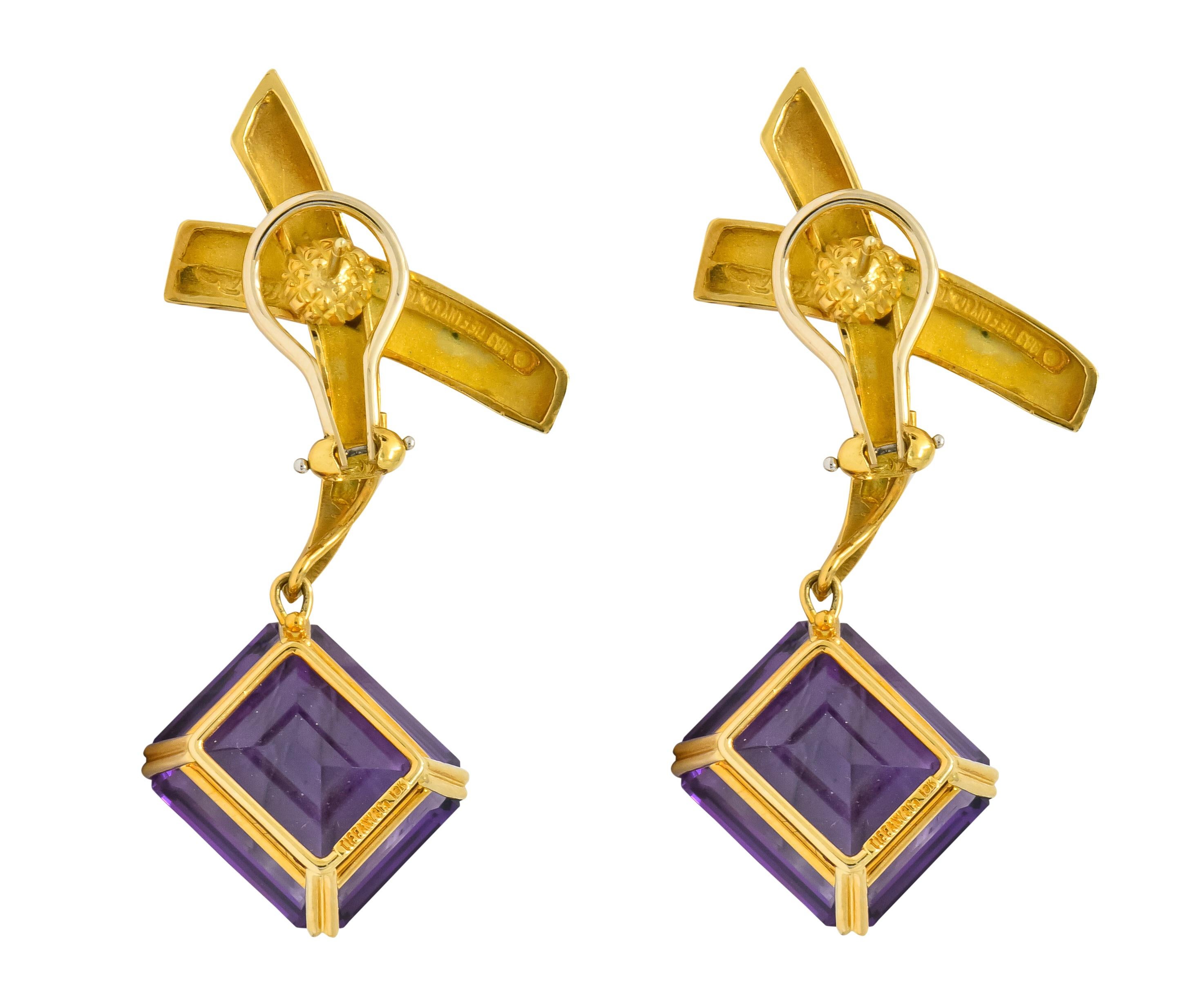 Designed as a stylized gold 'X' suspending an articulated basket set amethyst drop

Amethysts are emerald cut and an incredibly well-matched purple color, weighing 32.00 carats total

Each amethyst drop is removable from X surmount

Completed by
