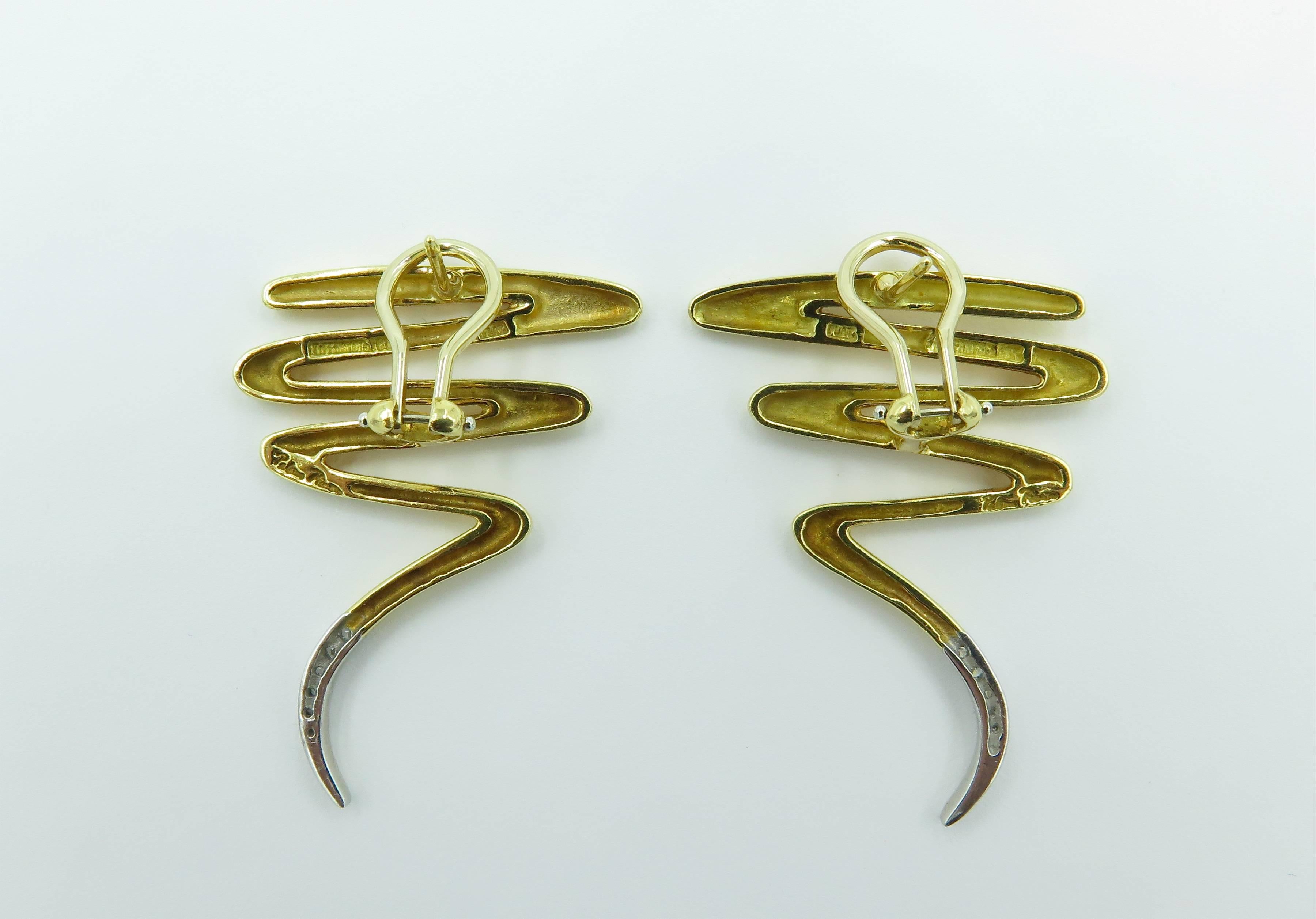A pair of 18 karat yellow gold, platinum and diamond Scribble earrings. Paloma Picasso, Tiffany & Co. In polished gold, enhanced by circular cut diamonds at the bottom. Length is approximately 1 1/2 inches, gross weight is approximately 15.5 grams.