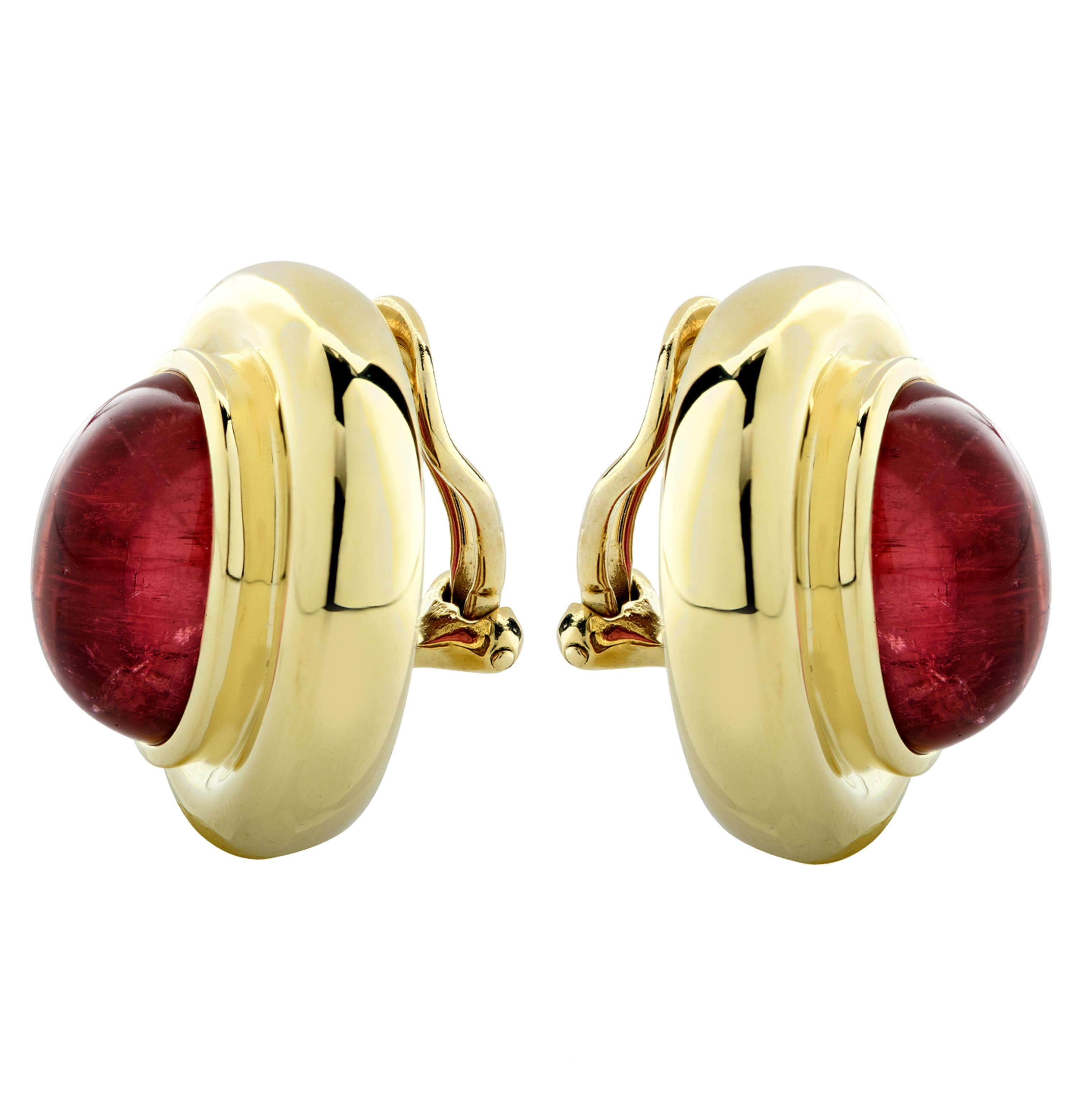 Striking Paloma Picasso Tiffany & Co. clip-on stud earrings crafted in 18 karat yellow gold, showcasing two oval cabochon Rubellite Tourmalines resting on a yellow gold bed. These stunning earrings measure 0.97 of an inch in length and 0.81 of an