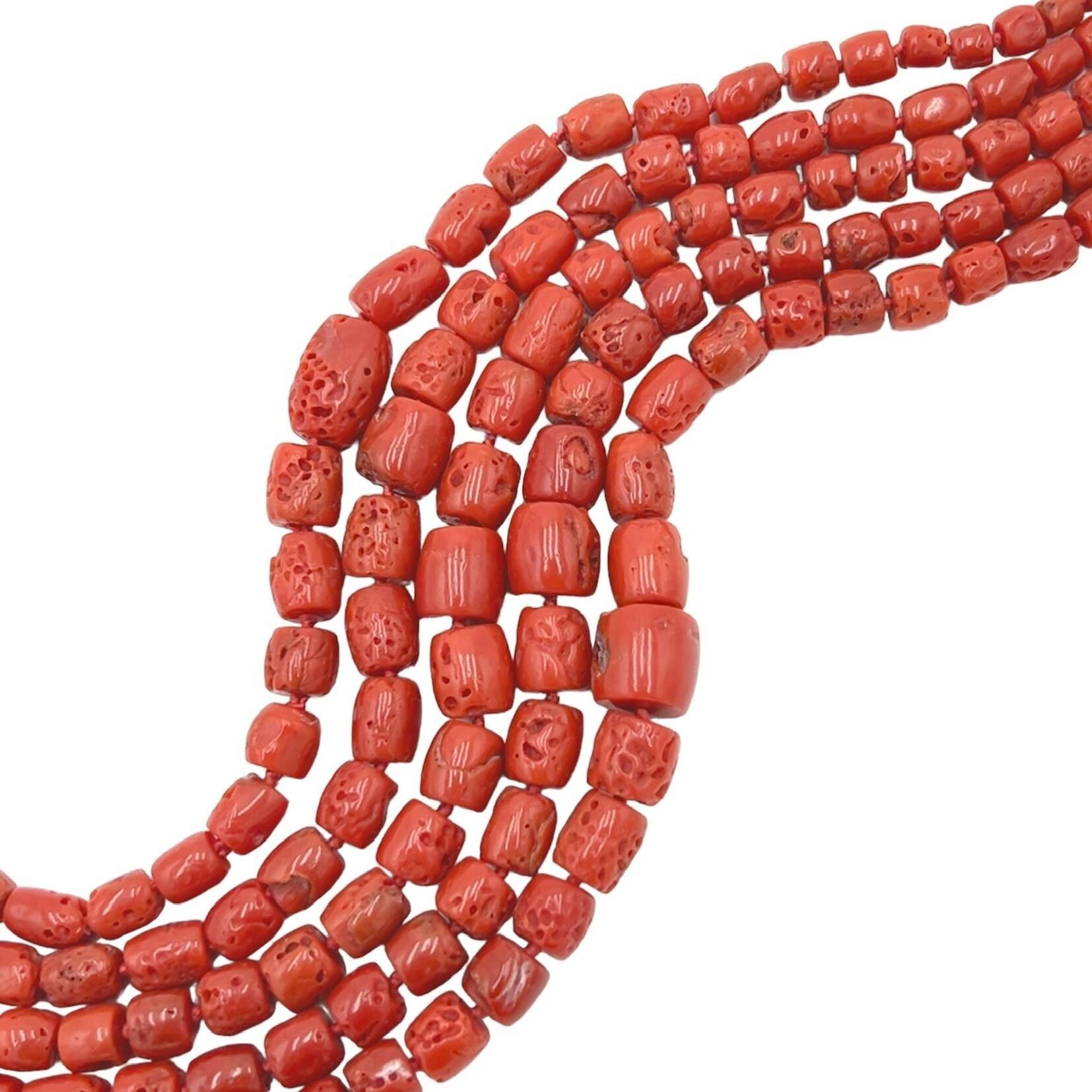 An 18 karat yellow gold and coral bead necklace, Paloma Picasso, Tiffany & Co.  Designed as five (5) nested strands of graduated barrel shaped sponge coral beads completed by a clasp of interlocking circles.  Length approximately 20 inches.  Gross