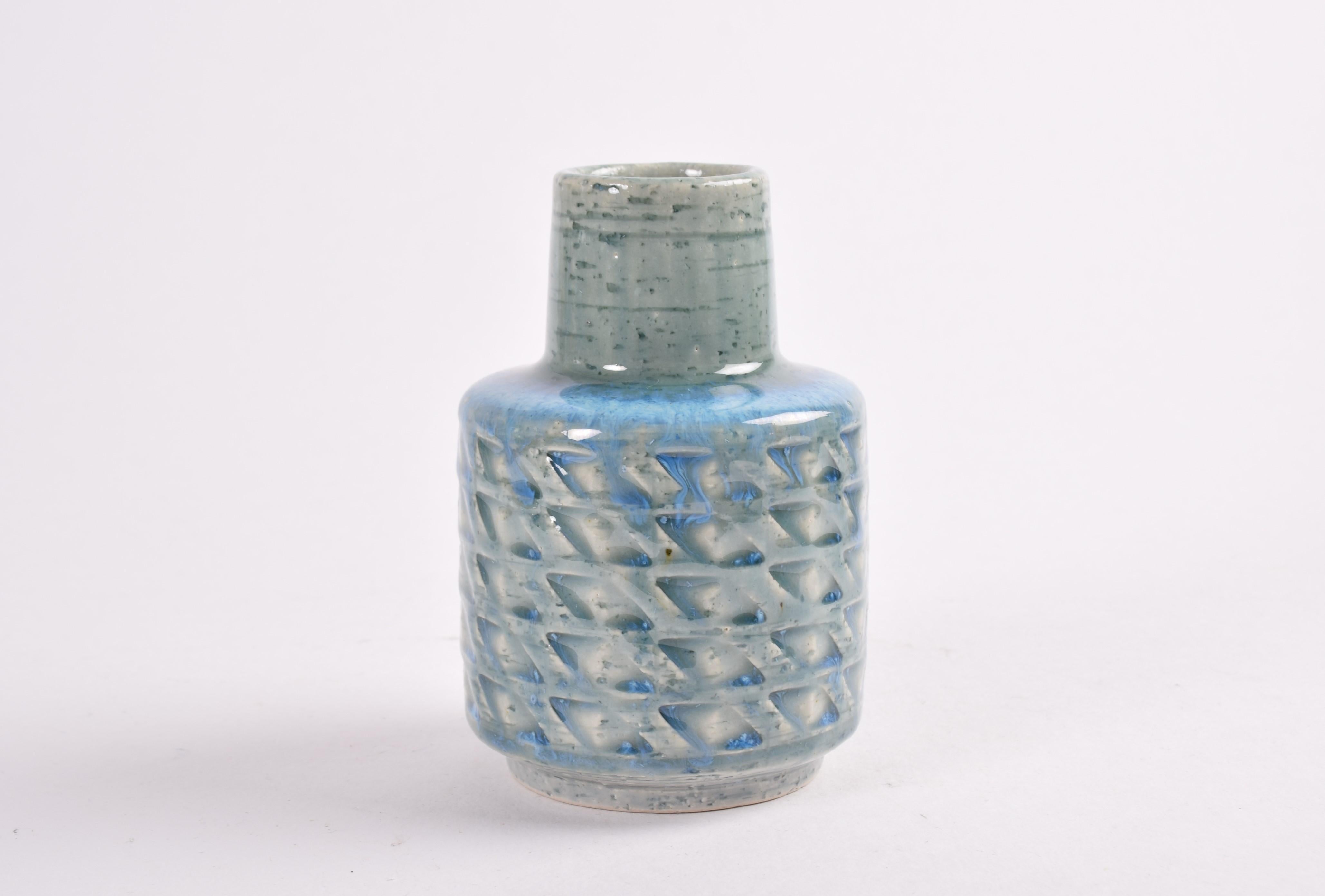 Ceramic vase by Per Linnemann-Schmidt for Palshus Denmark. Made in the 1960s.
It is made with chamotte clay which gives a rough and vivid surface. It has a shiny bright blue glaze over a textured zig zag decor.

Fully marked on bottom.