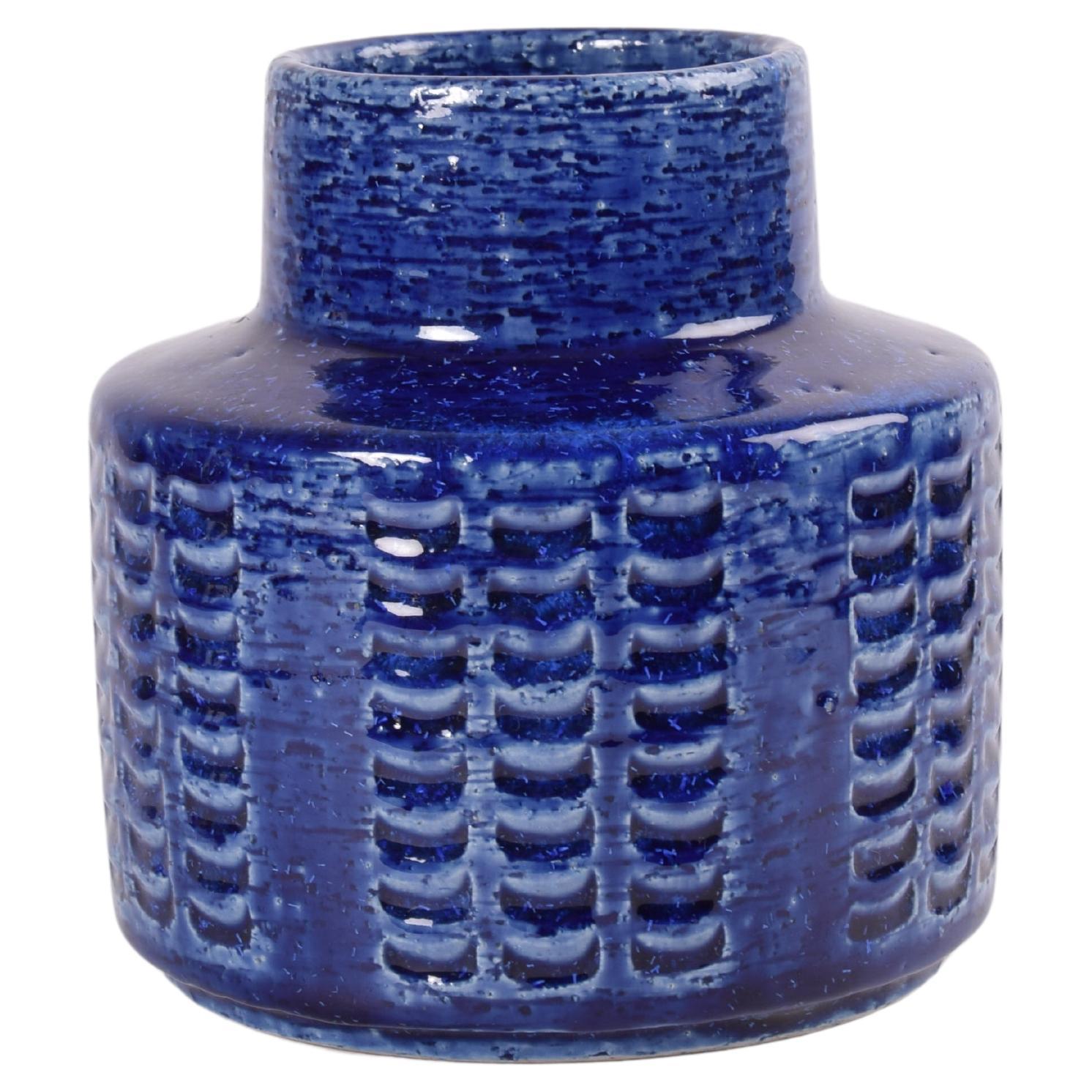 Ceramic vase by Per Linnemann-Schmidt for Palshus Denmark. Made in the 1960s.
It is made with chamotte clay which gives a rough and vivid surface. It has a shiny cobalt blue glaze over a textured decor.

Fully marked on bottom. 

Factory