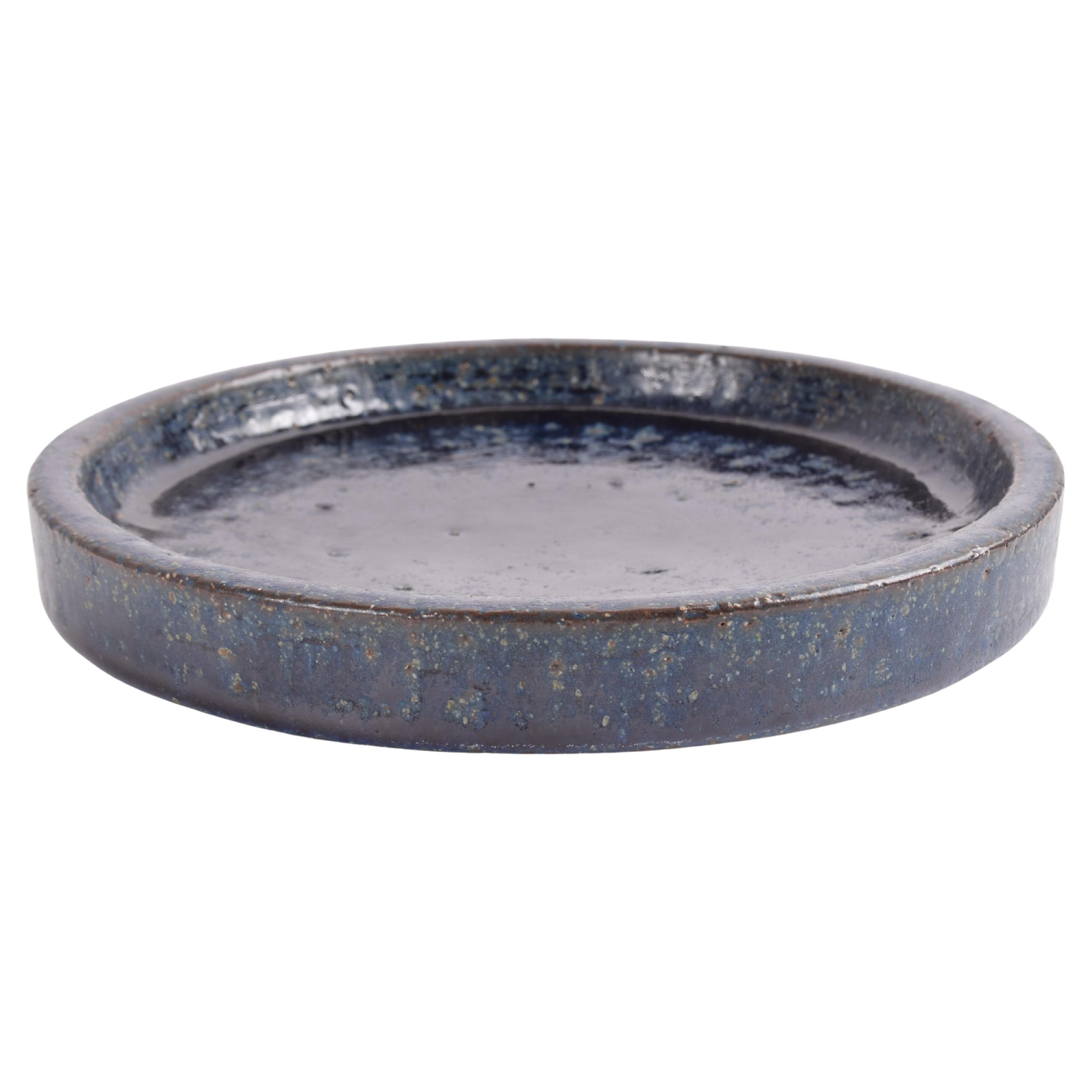 Low ceramic bowl by the acknowledged Danish ceramic workshop Palshus. It is designed by Per Linnemann-Schmidt and made in the 1960s or early 1970s.

The bowl is made from chamotte clay and has an interesting midnight blue glaze with brown elements