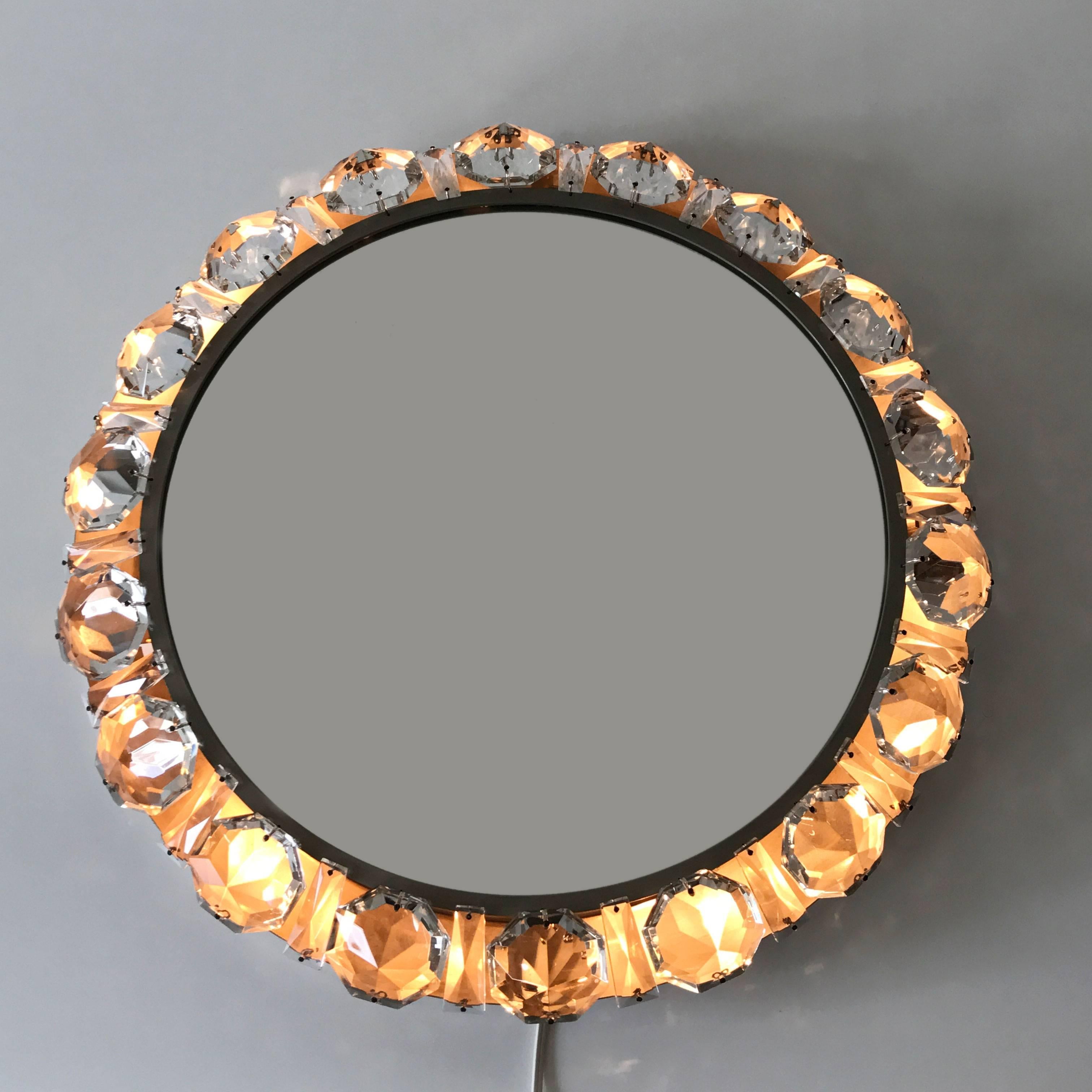Highly decorative Mid Century Modern backlit wall mirror with a nickel-plated brass frame and large crystal elements. Designed and manufactured by Palwa, Germany, 1960s. 

Executed in crystal glass elements, nickel-plated brass and mirrored glass,