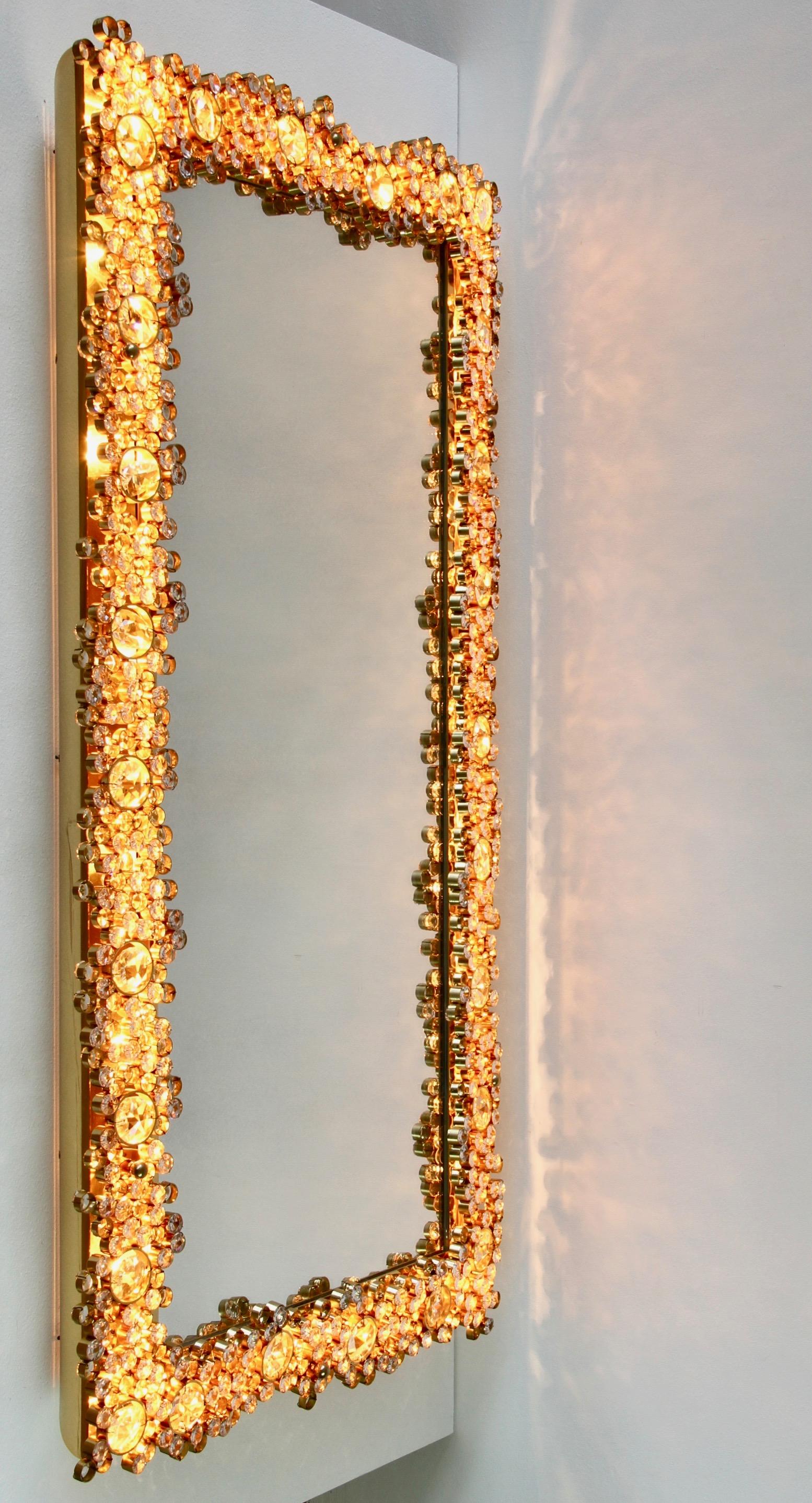 Stunning & large rectangular Mid-Century gilt brass and crystal wall-mounted backlit vanity or hallway mirror by Palwa, Germany, circa 1965-1975. Perfect for the Hollywood Regency style, there is no better combination than gold and crystal for the