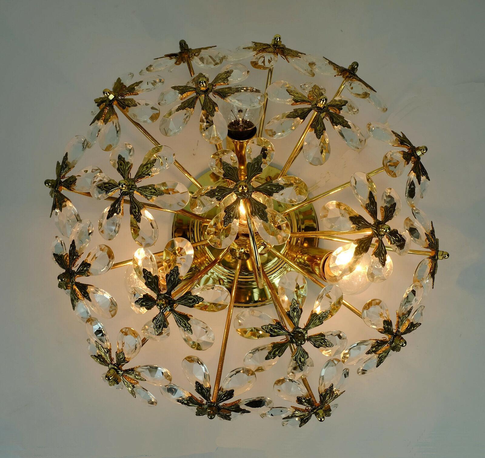 Very beautiful midcentury ceiling fixture manufactured by Palwa (Palme & Walter) in the 1970s. The shade consists of 19 large blossoms made of faceted crystal glass and brass. The center is made of brass. Holds 4 E14 bulbs (not included). 

Very