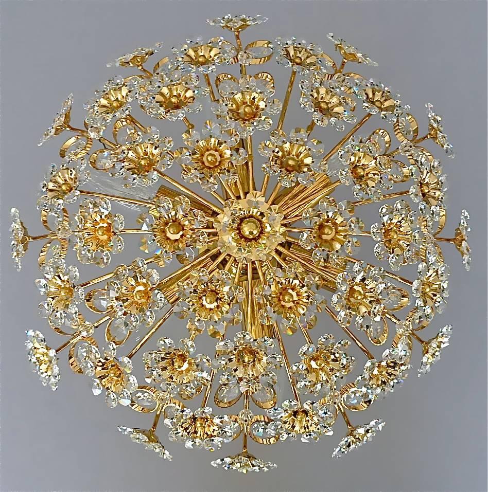 Round gilt brass metal crystal glass flush mount chandelier made by Palwa, Germany, circa 1960-1970, documented in the Palwa sales catalog and signed with Palwa company label and model number. The gorgeous ceiling light has lots of beautiful