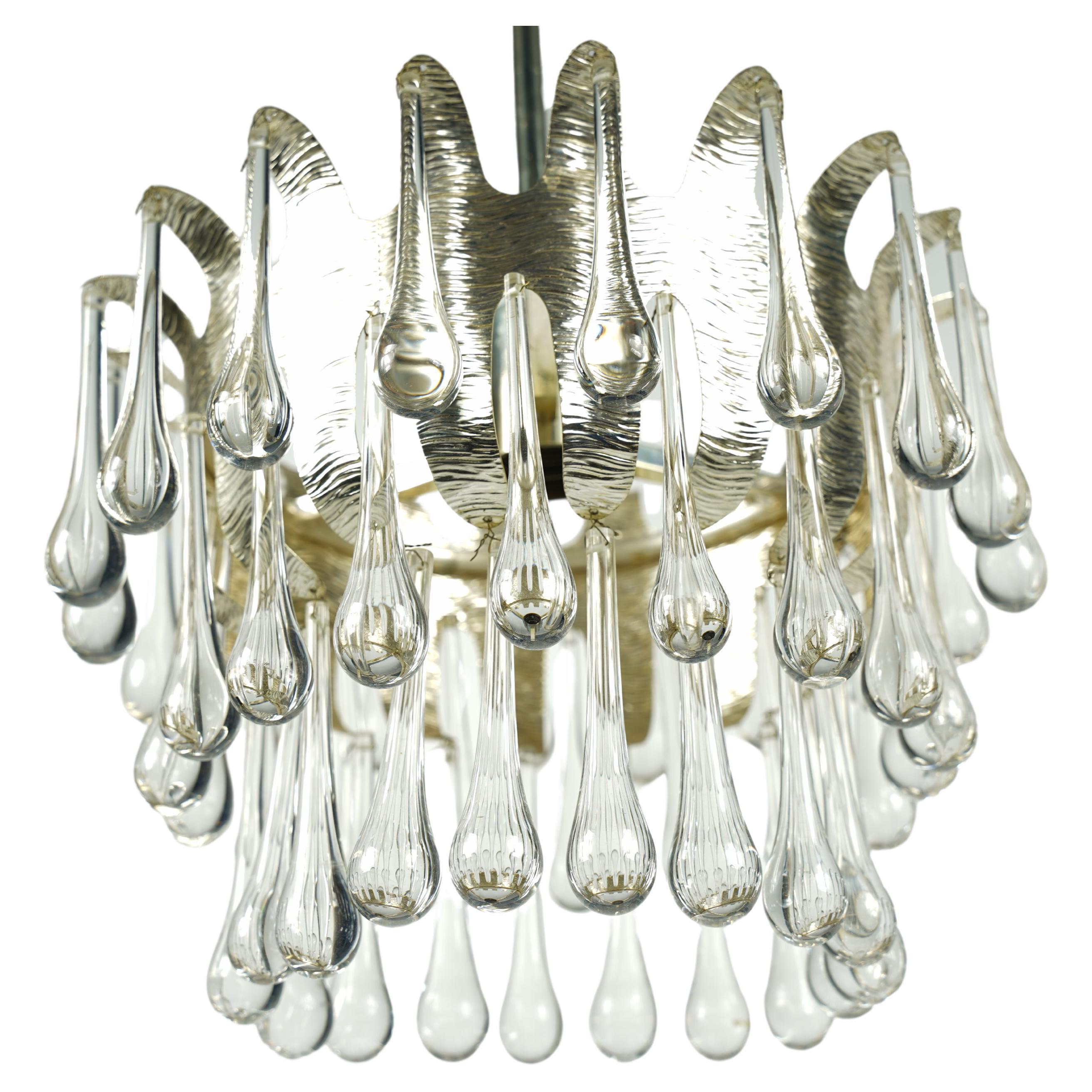 Gilt metal frame with organically inscription on the metal, the frame has a single Edison bulb in the centre, the frame has three tiers of drop shaped crystal glass pieces.

Rewired for the US.

