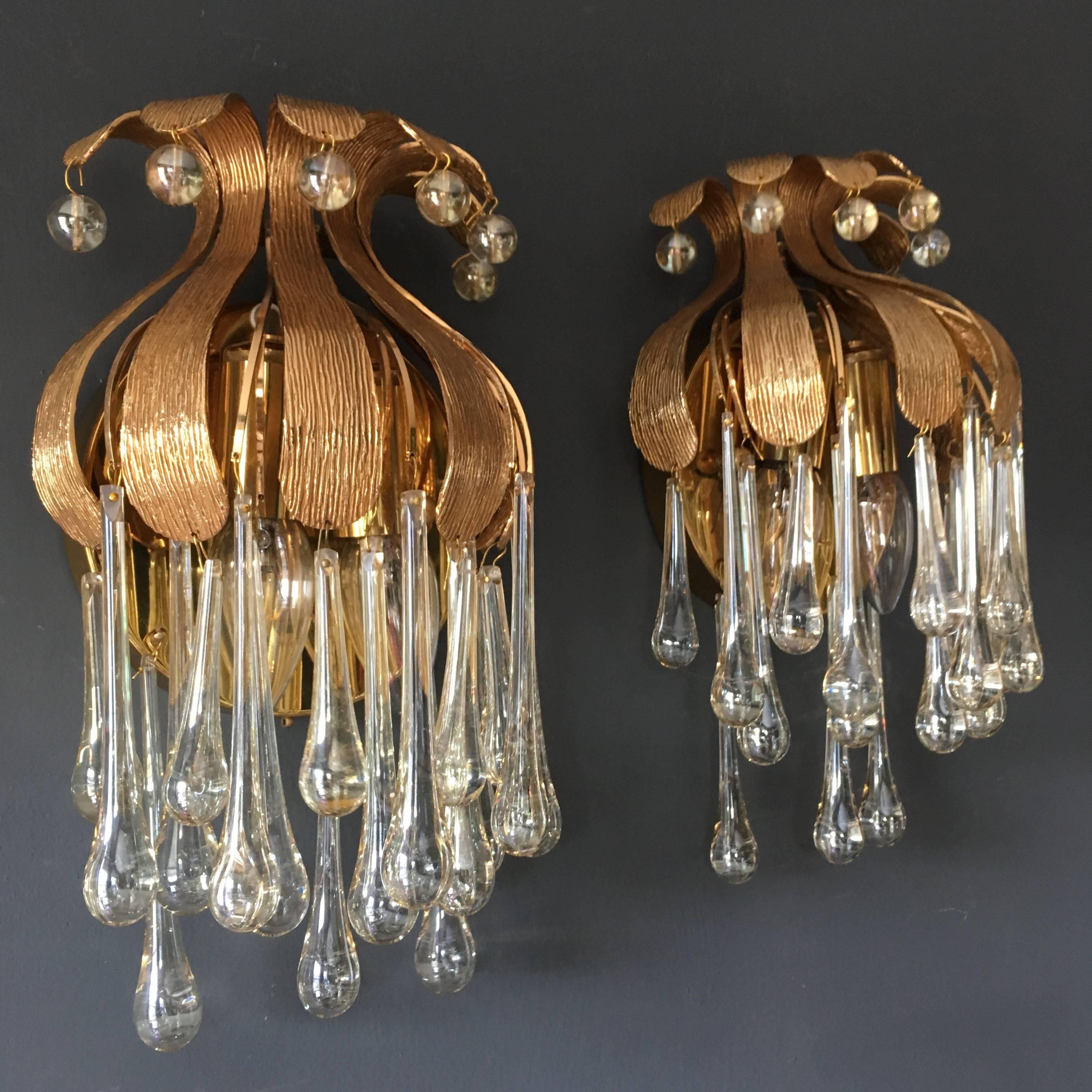 Two beautiful gold-plated brass wall sconces by Palwa, Germany, circa 1970s.

They are decorated with Murano glass teardrop crystals all around and small Murano glass spheres around the top 

Measures: Height 34 cm
Width 20 cm
Depth 14