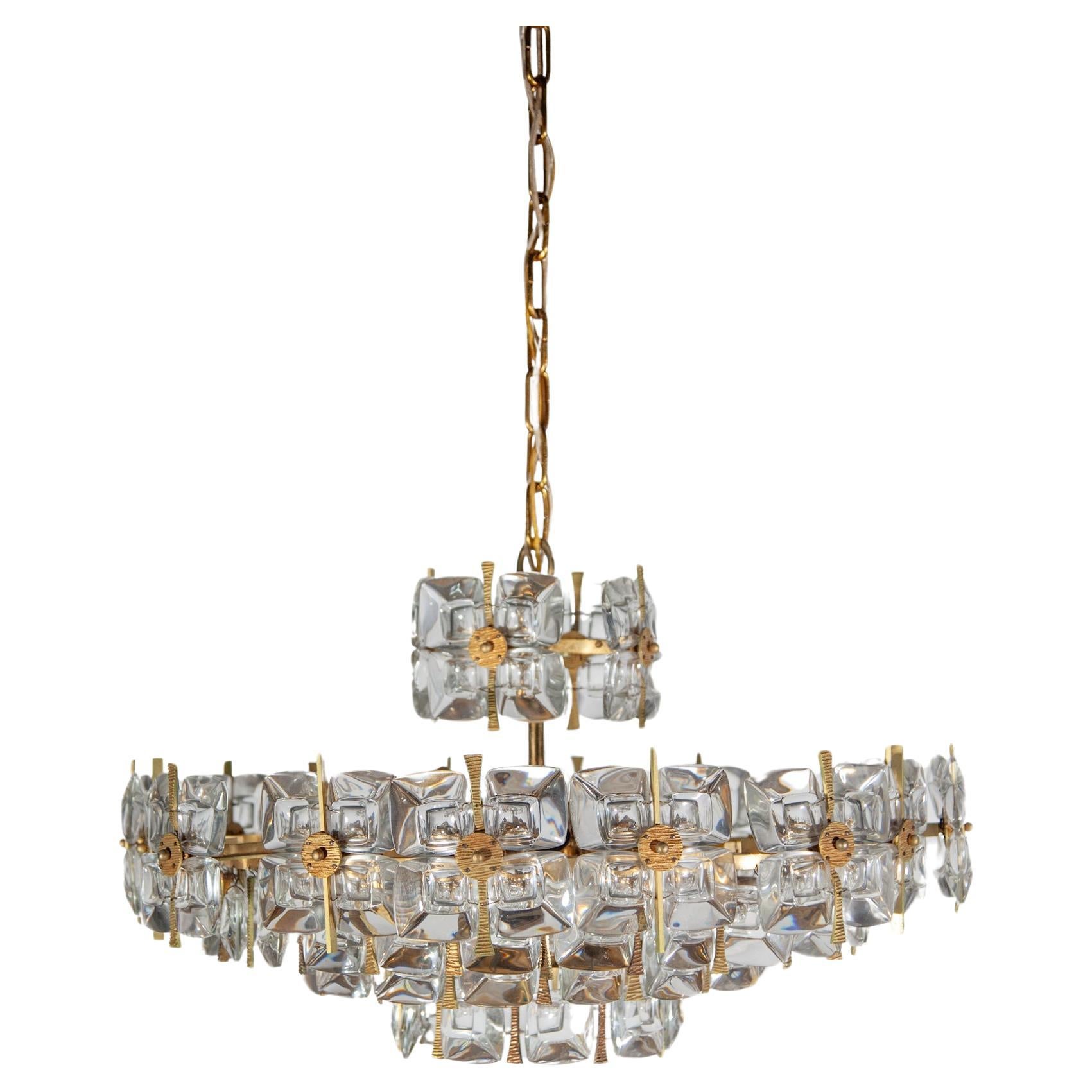 Large vintage Hollywood Regency style gilded brass and glass chandelier designed by Palwa, 1970s, Germany. The facetted glass parts look like huge jewels. A fantastic quality and in a very good original condition.