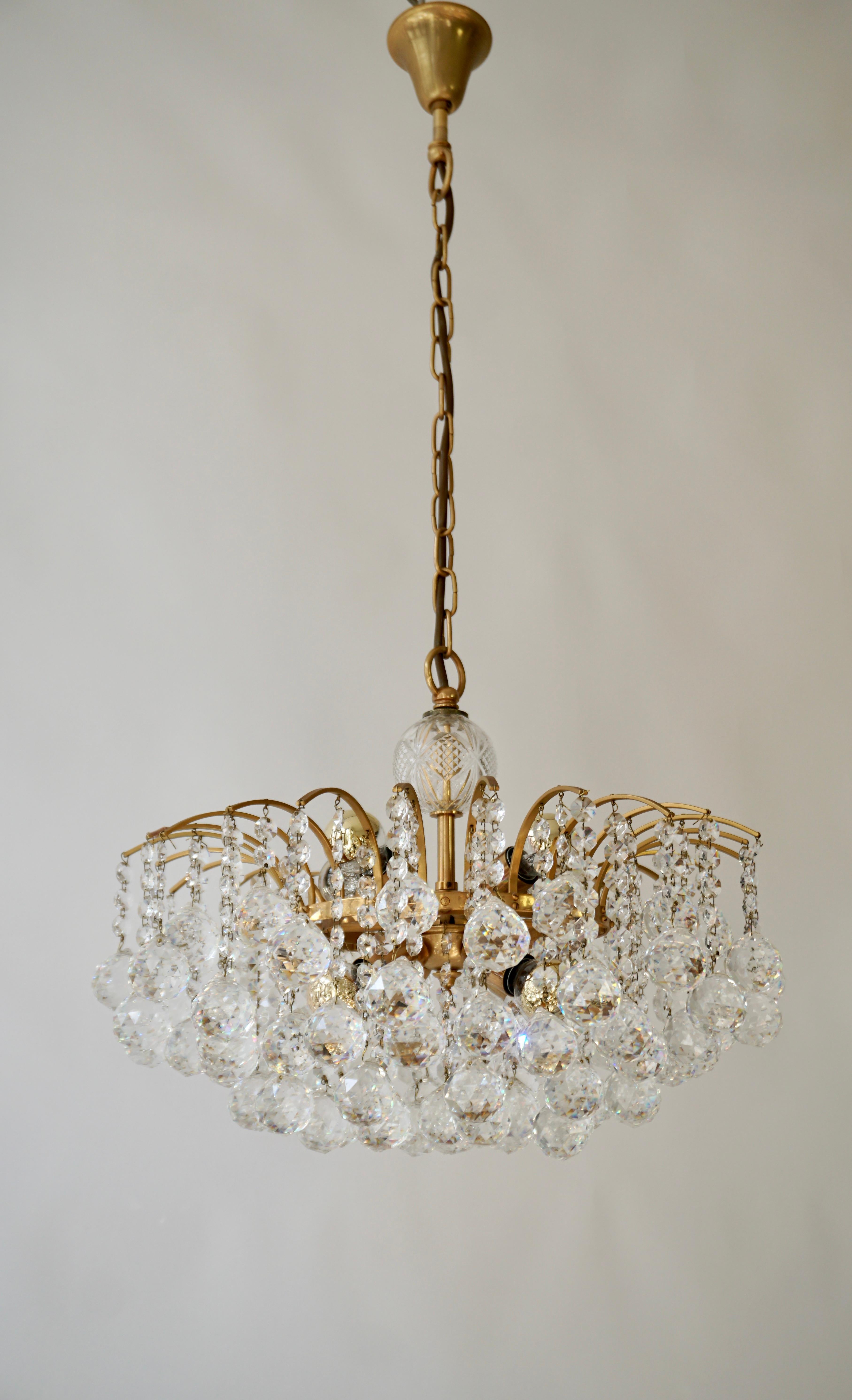 Precious gilt brass and crystal glass Sputnik chandelier made by Christoph Palme or Palwa, Germany, circa 1960-1970. 

The chain-hanging chandelier has a gilt brass Sputnik construction with lots of high lead hand-cut faceted octagonal crystal