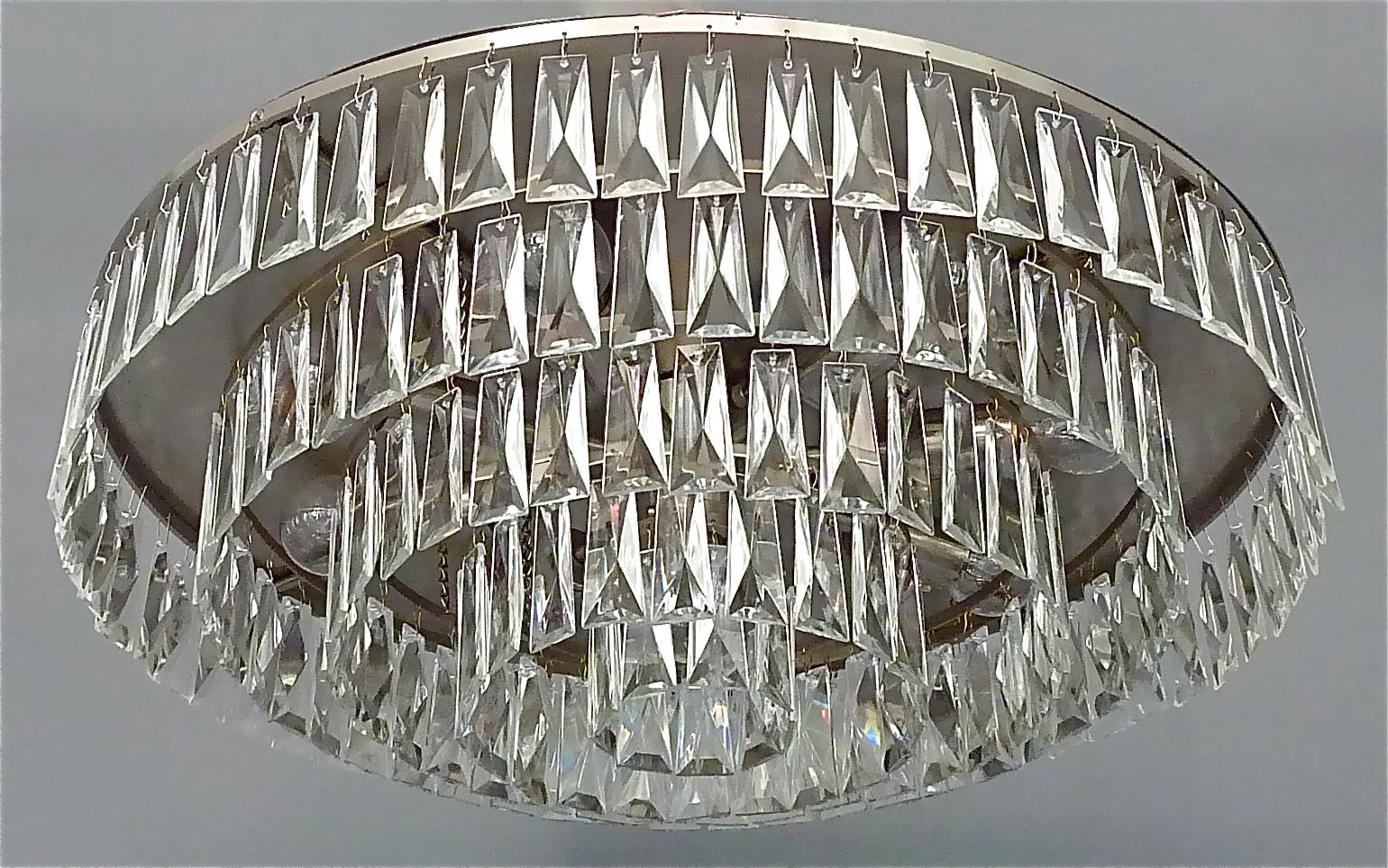 Early and large midcentury Palwa flush mount chandelier or ceiling light, Germany, circa 1960s. The ceiling fixture and the frame are made of brushed stainless steel metal. It has five tiers with handcut faceted crystal glass beads, made of the high