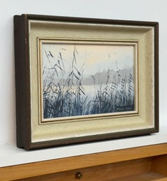 Serene lakeside scene with delicate reeds in soft, misty twilight tones