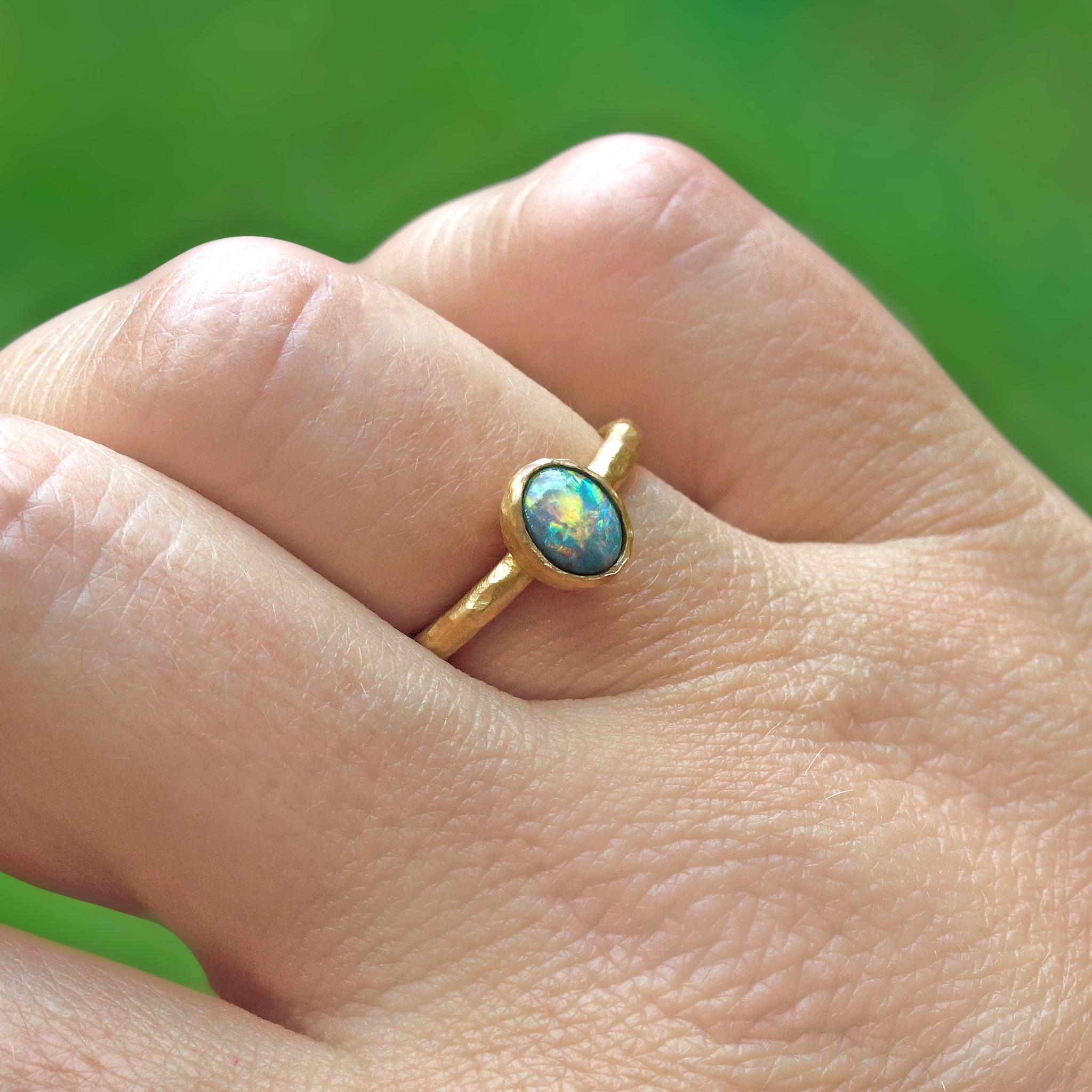 One-of-a-Kind Ring handcrafted by jewelry artist Pamela Froman in her signature hammered and matte-finished 18k yellow gold showcasing a very fine 2.43 carat Lightning Ridge black opal oval cabochon featuring primary red and orange flash. Size 5.75