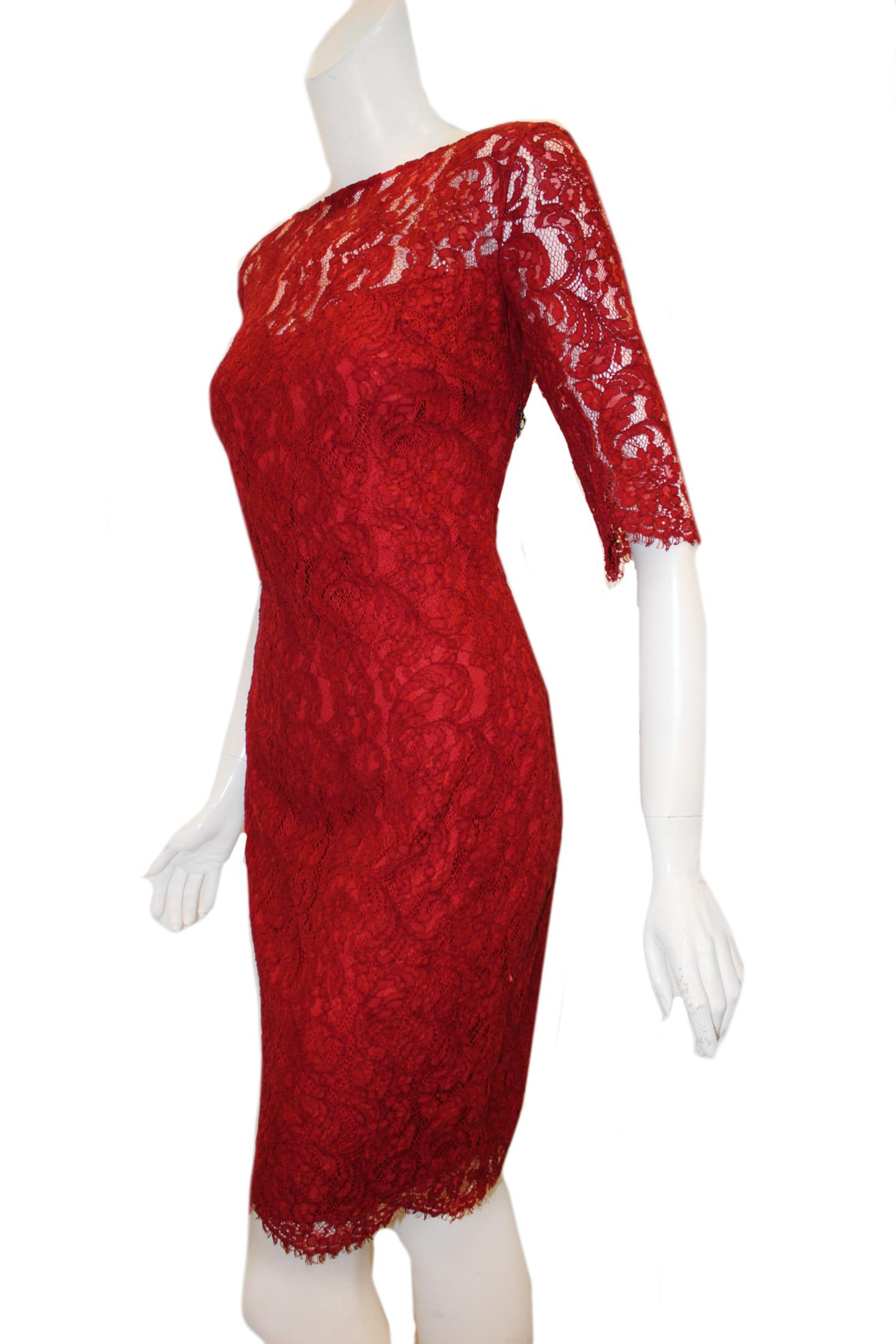 Pamella Roland Ruby red lace dress is showing of the shoulders and arms since this part of the dress is not lined.  The to the elbow sleeves are scalloped at edges for a more feminine look.  The dress is fitted to the body and lined in ruby red