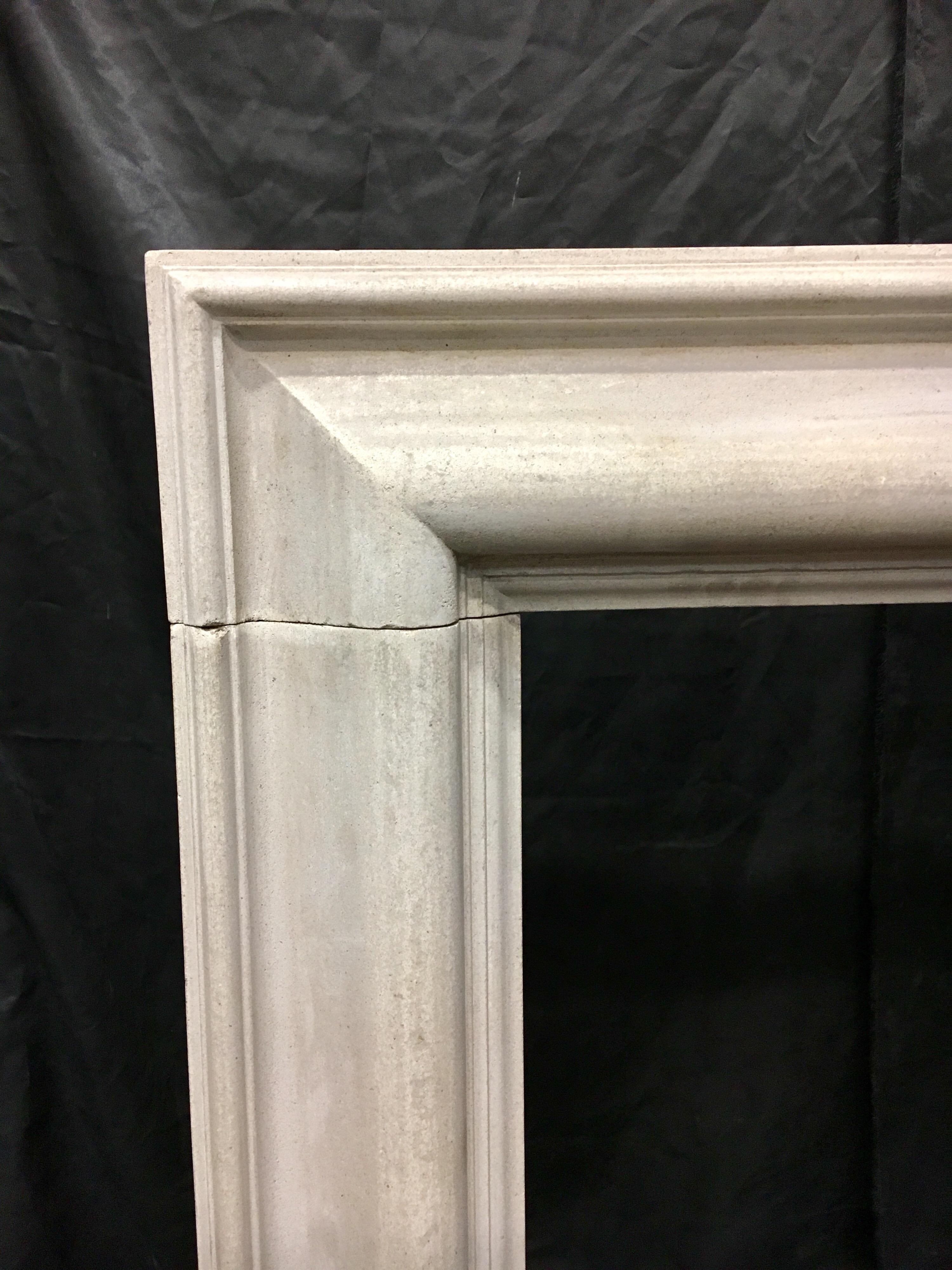 A petite  Edwardian reconstituted stone bolection of simple form- finishing on to square foot blocks, this would suit a smaller room.

English, circa 1925. 

Measures: Fire opening: 840 mm wide x 760 mm high.
Width over the foot blocks: 1223 mm.