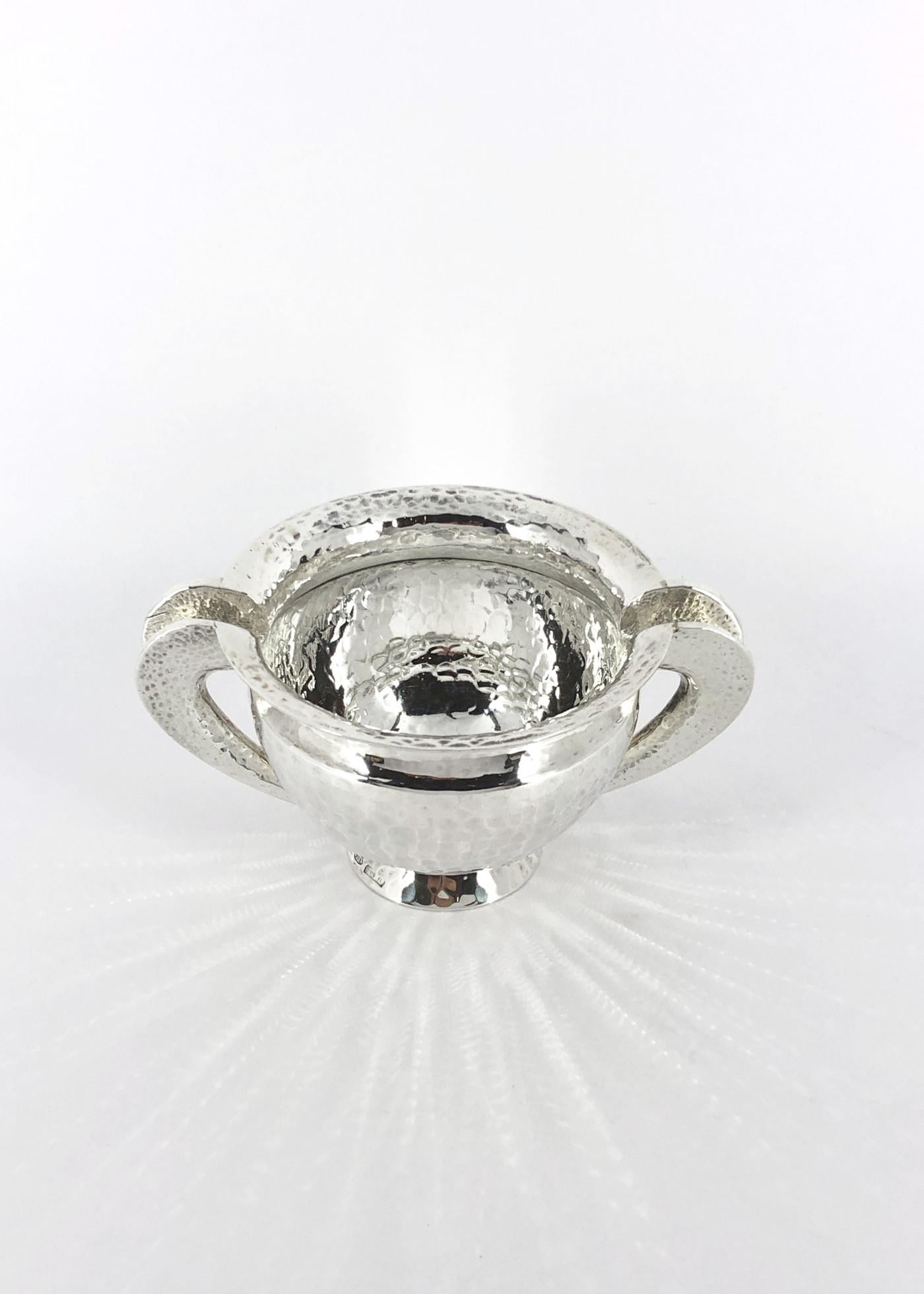 Vaso piccolo in argento 925/ooo, collezione Troia, prodotto da Pampaloni Firenze Italia. Peso g 135, diametro cm 7,5, incluso i manici cm 10,5, altezza cm 5,5.
Superficie martellata con finitura lucida

La collezione Troia, che comprende oggetti in