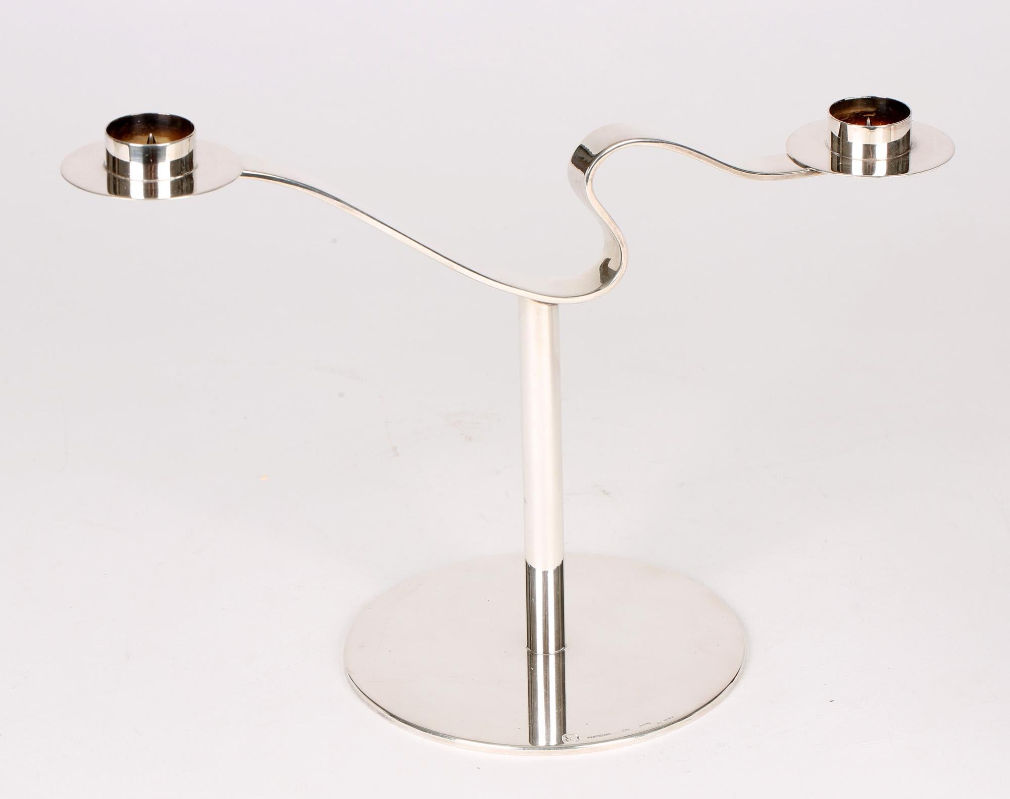 A exceptional quality and heavy gauge Italian silver modernist twin candlestick by Pampaloni of Florence with London silver import marks for 2003. The candlestick stands on thick flat rounded base with a narrow rounded column stem supporting a