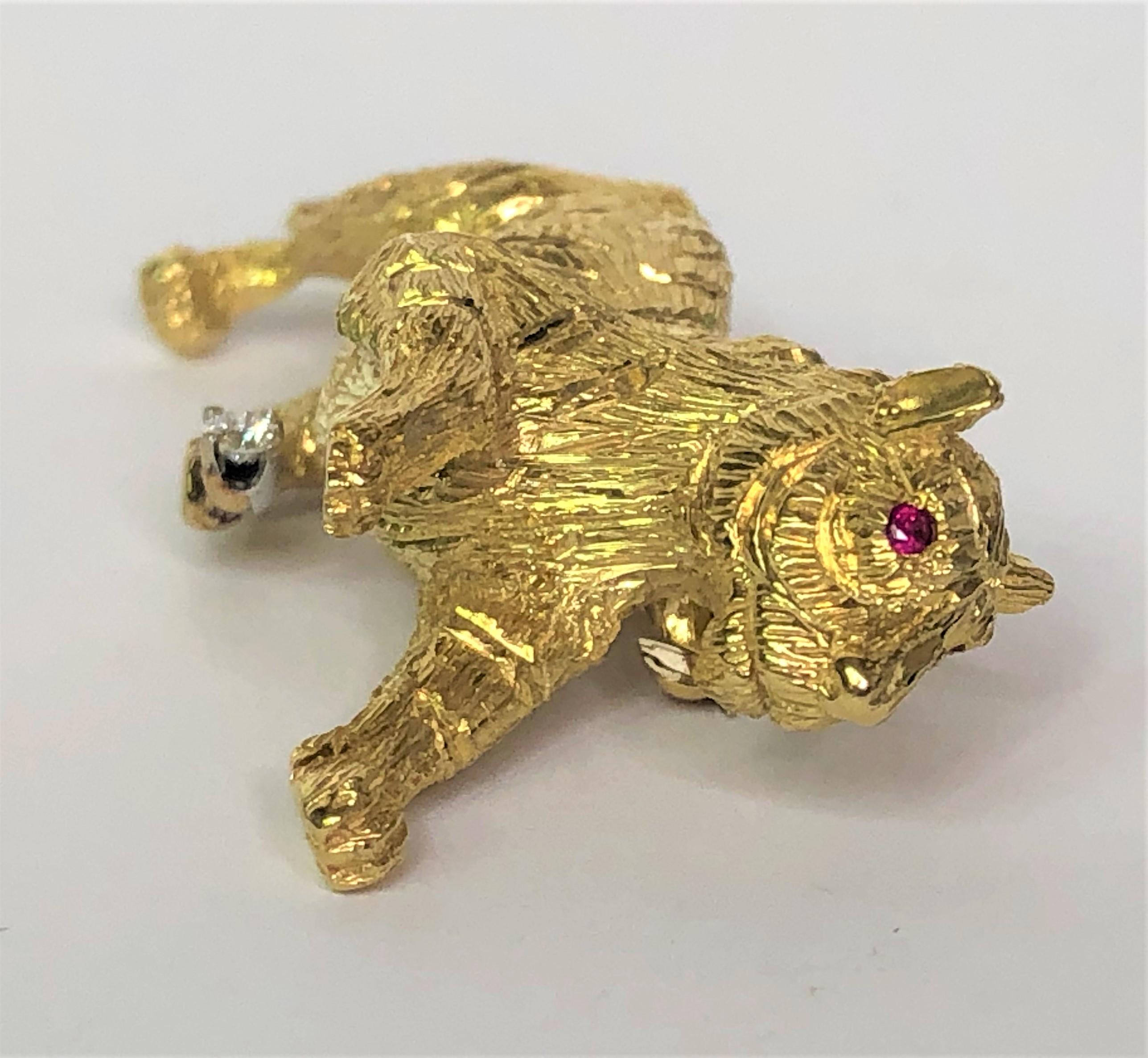 This tiger looks fierce and cute all at the same time!  Go Cincinnati Bengals!!
By Pampillonia Designs, Inc. 
18 karat yellow textured gold body.  
Two round ruby eyes.
One round prong set diamond on top of tiger's back foot.  .05ct.
Stick pin runs