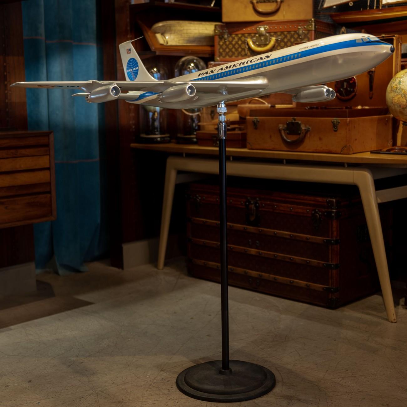 An exceptional large scale vintage fiberglass and resin composite promotional model of a Boeing 707 in Pan Am’s iconic livery on original steel and cast iron floor stand with ball and socket mount so the plane’s position can be adjusted as desired,