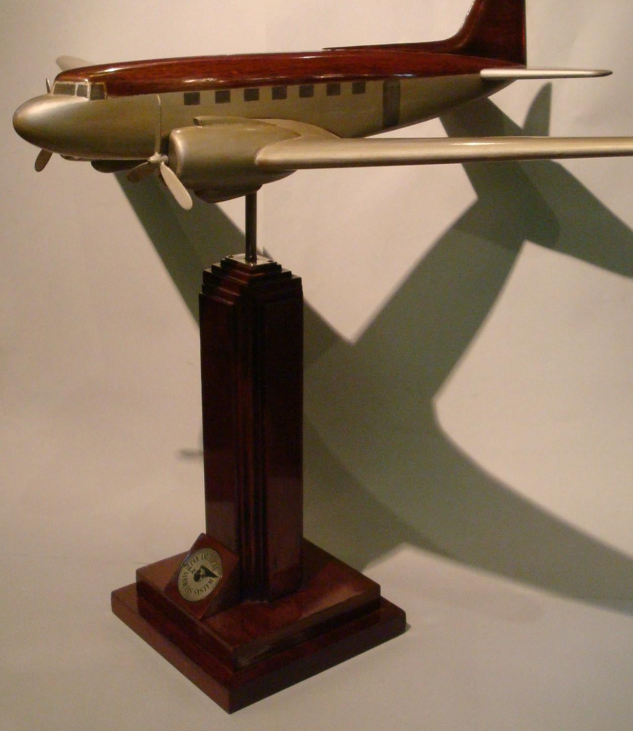 Art Deco / midcentury large DC3 desk aviation model.
Pan-Am wooden airplane model.
It was in an office of the company in South America.
Very good restored conditions. Slight age wear.

History
Pan American Airways began the first transatlantic